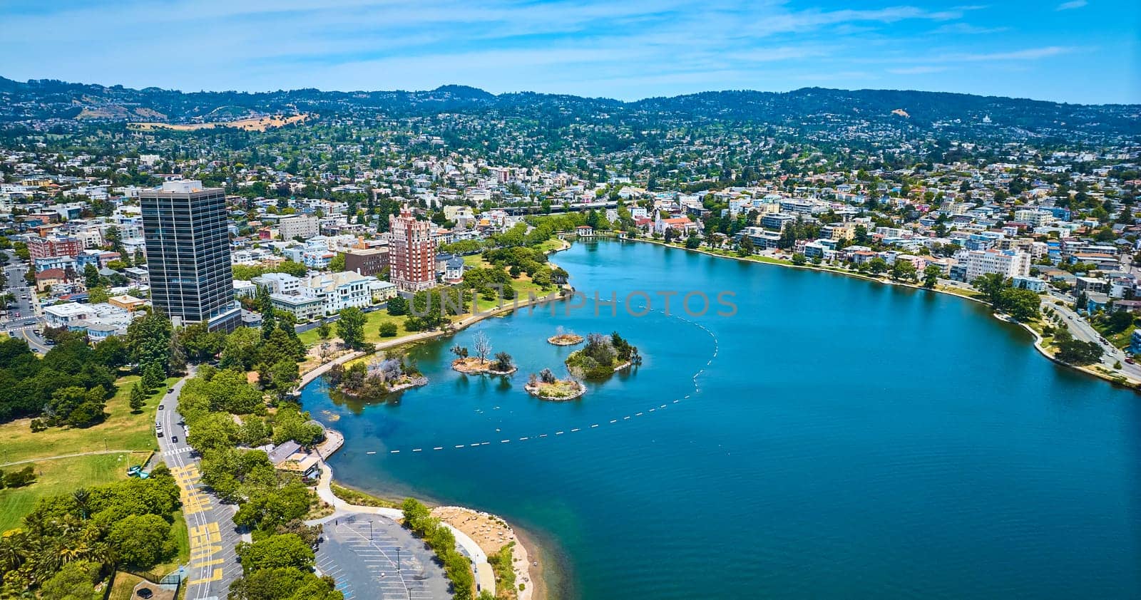 Image of Bellevue Staten building on Lake Merritt shore with Pelican Island aerial of residential area