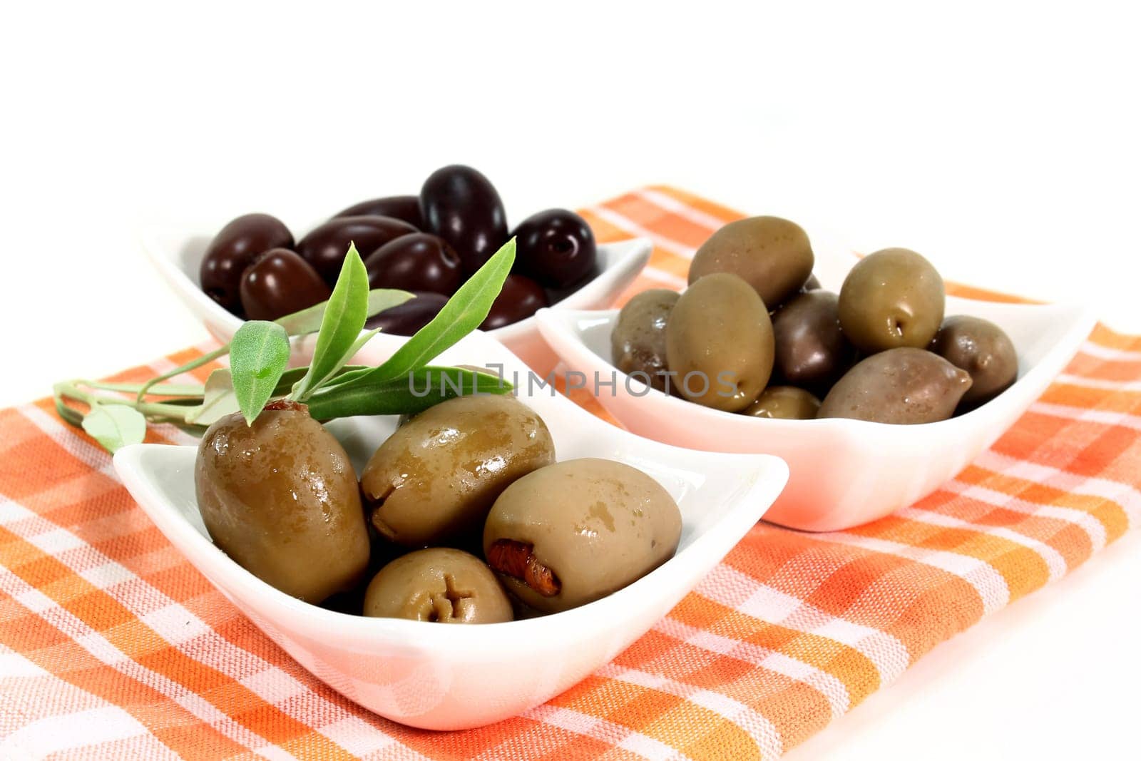 different varieties of olives with olive branch