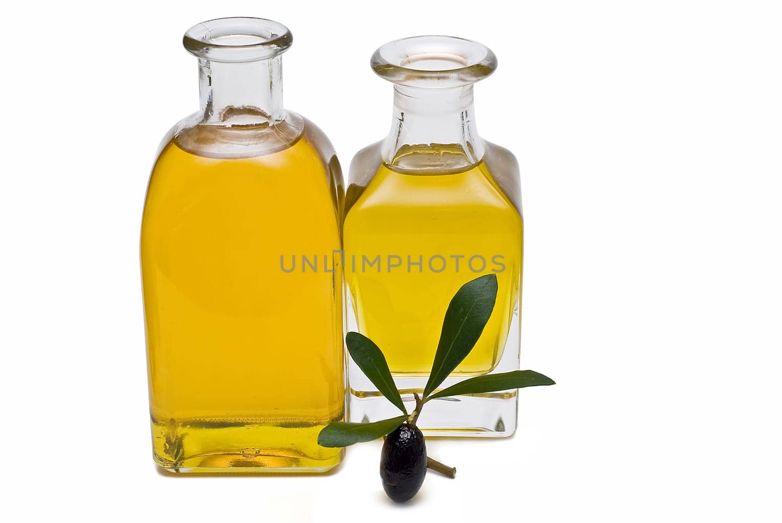Virgin olive oil and olives isolated on a white background.
