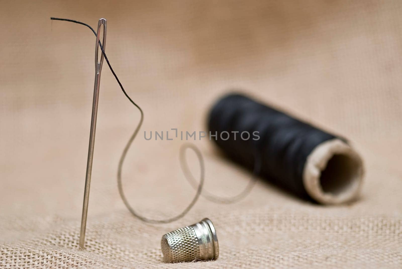 Traditional sewing items on a burlap surface.