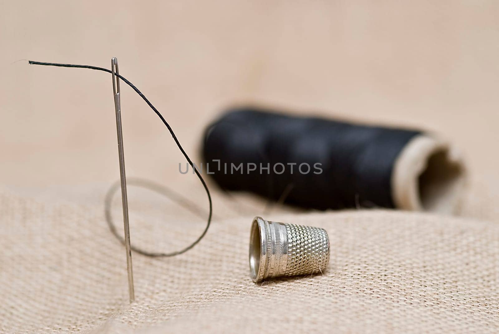 Traditional sewing items on a burlap surface.