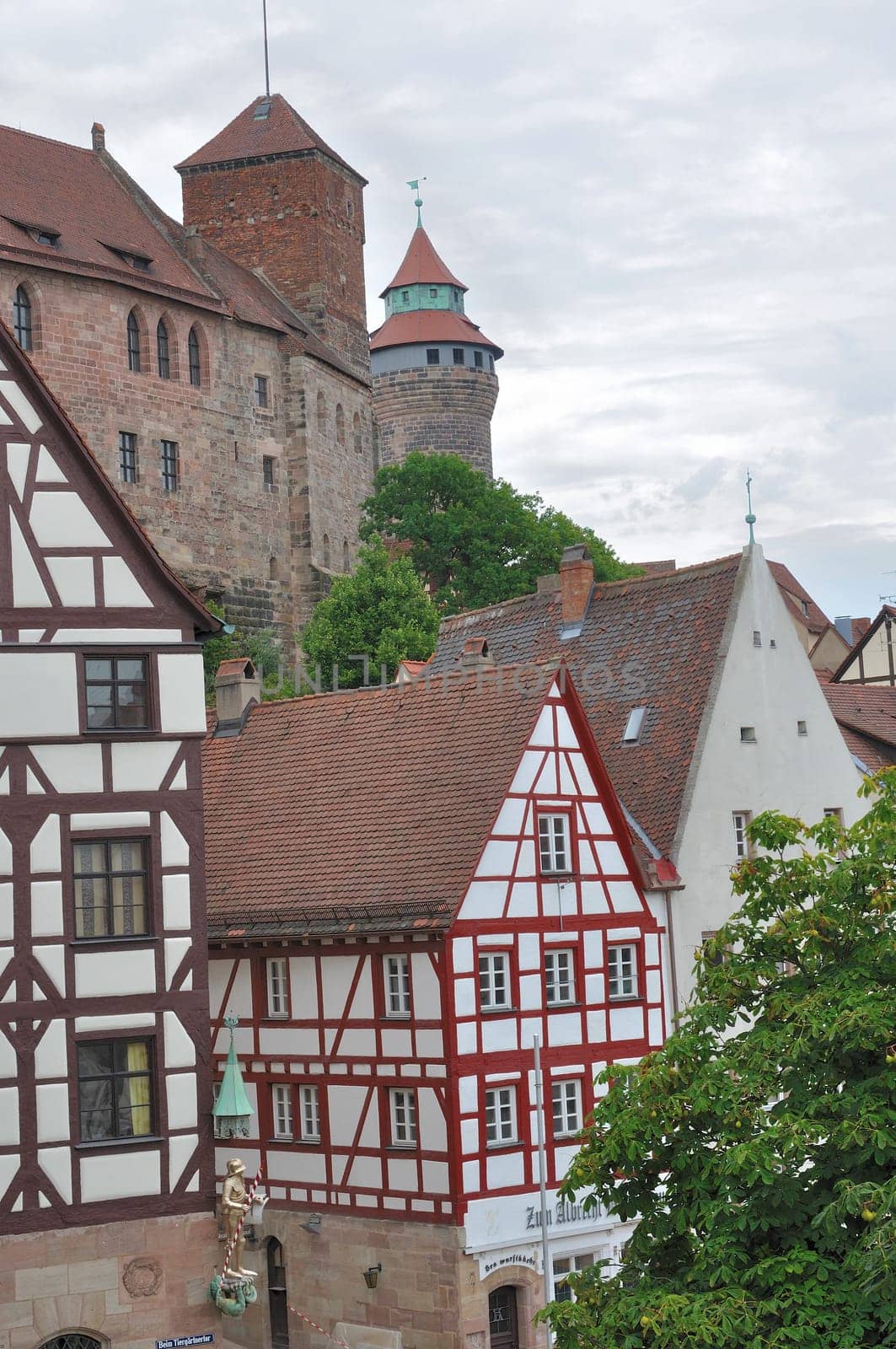 view of old wattle houses in city center with the ancient castle on background
