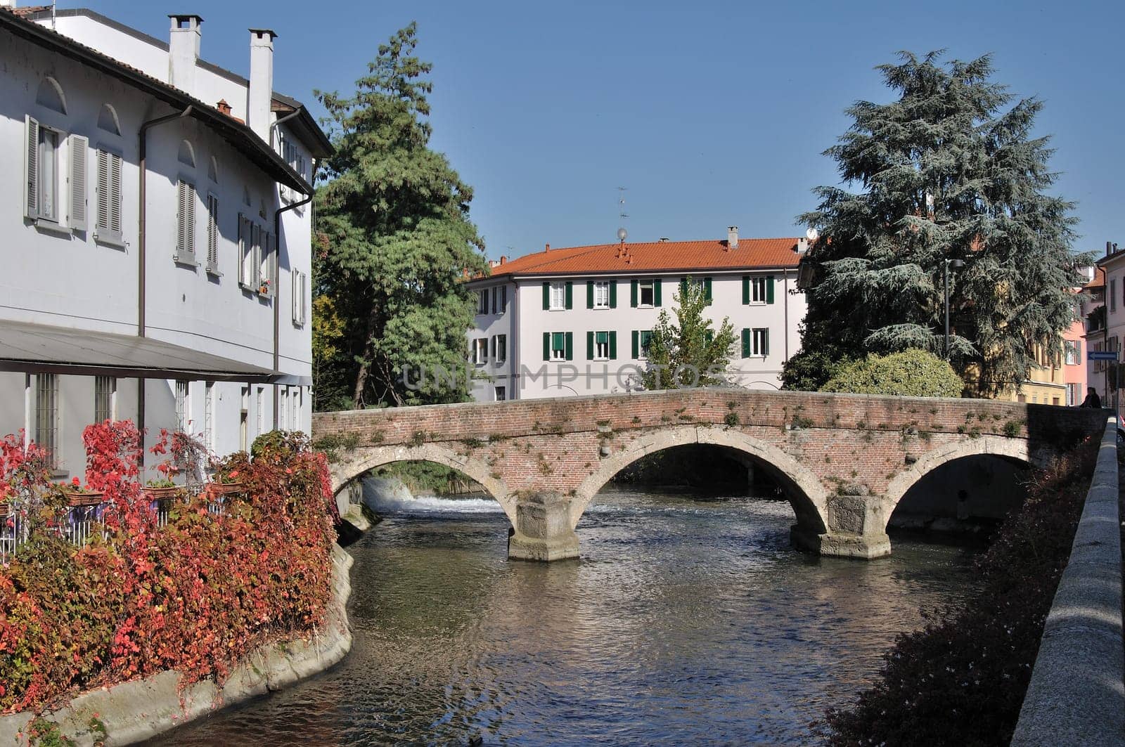 ancient bridge over a derivation of lambro river in monza city center, shot in fall