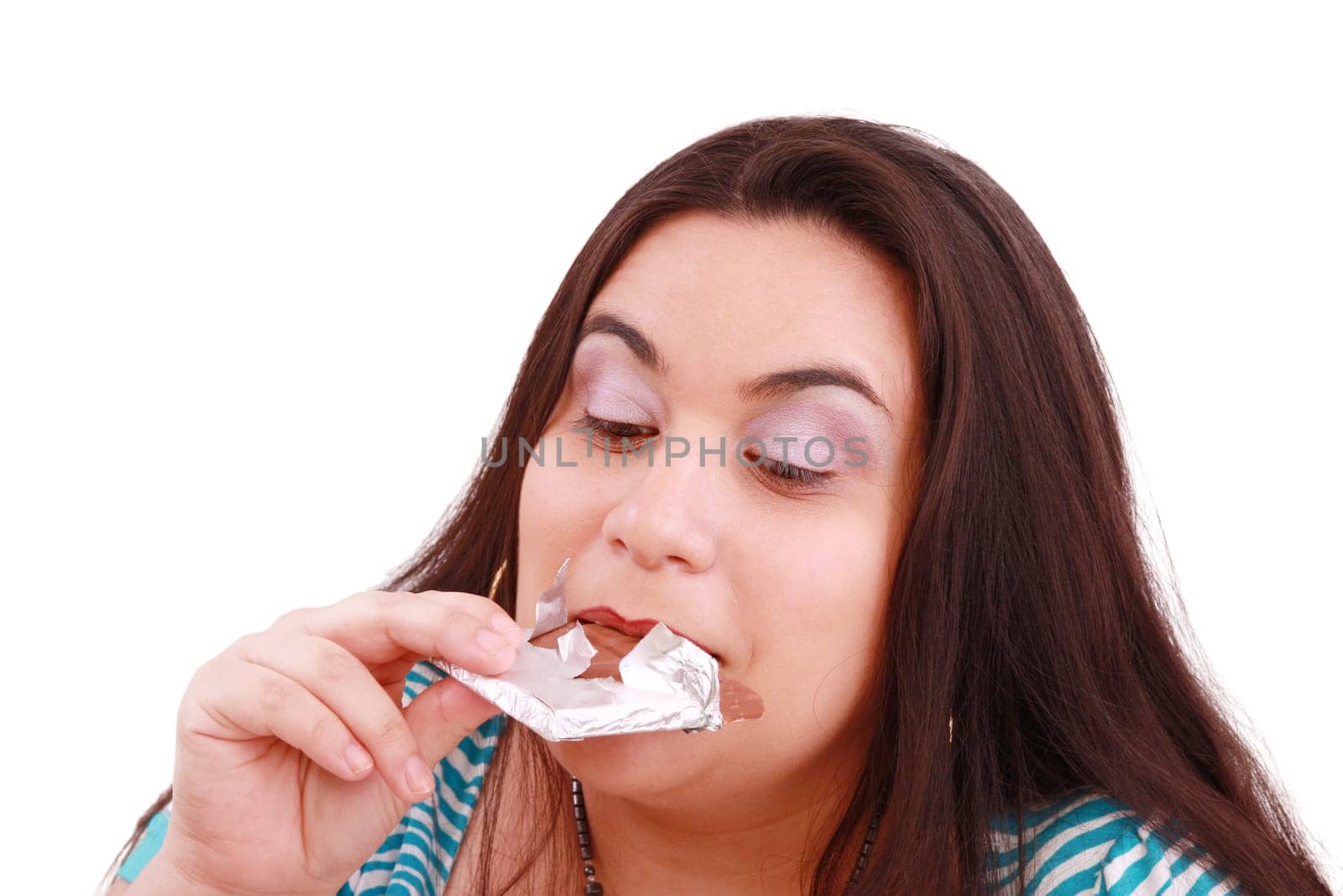 Crazy for chocolate, pretty young woman eating chocolate