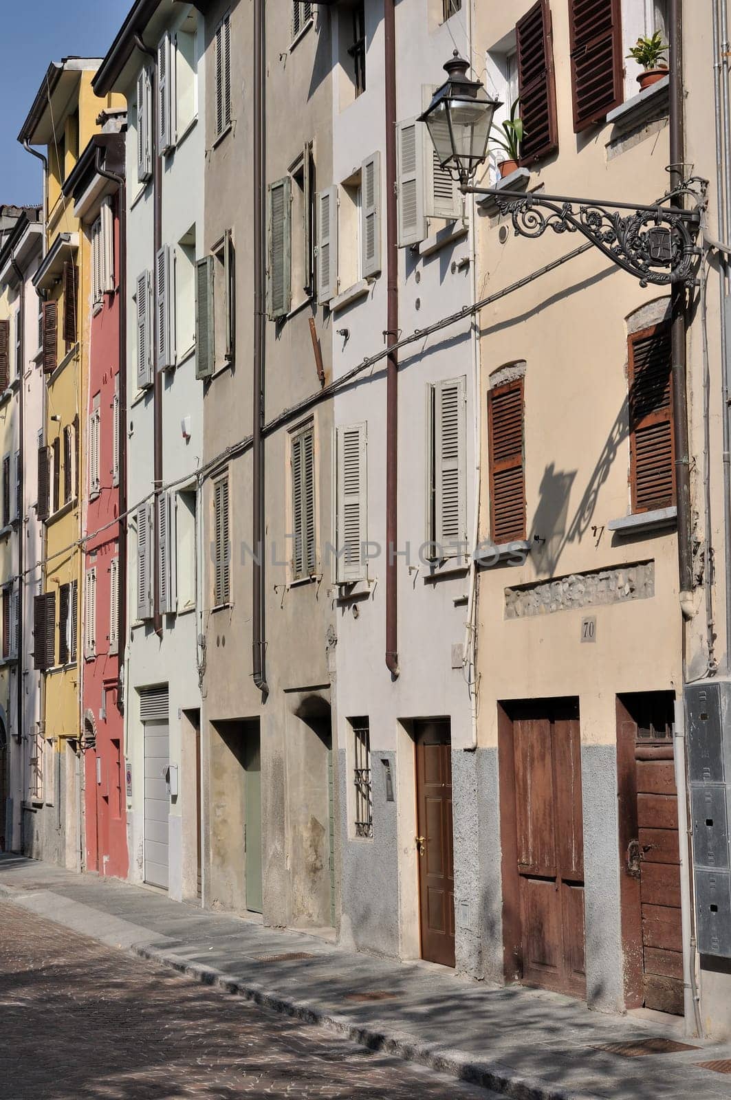 foreshortening of ancient residential buildings aligned on the street in parma citycenter