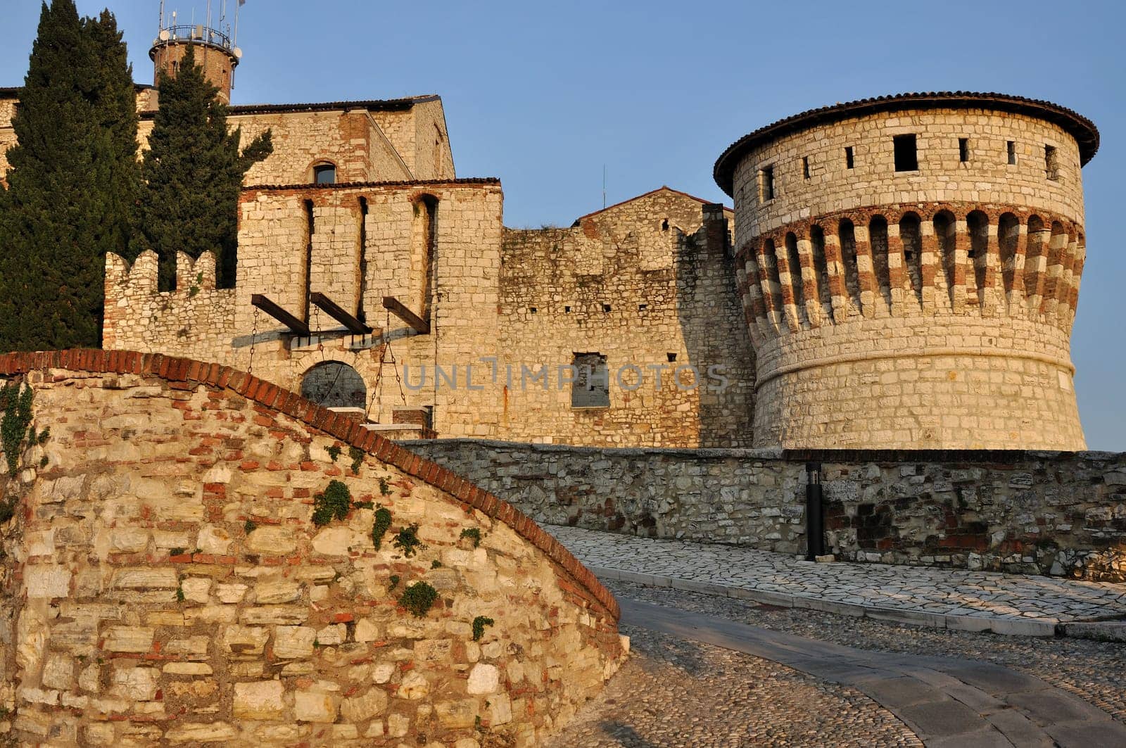 view of inner entrance of medieval castle on a hill towering above the town