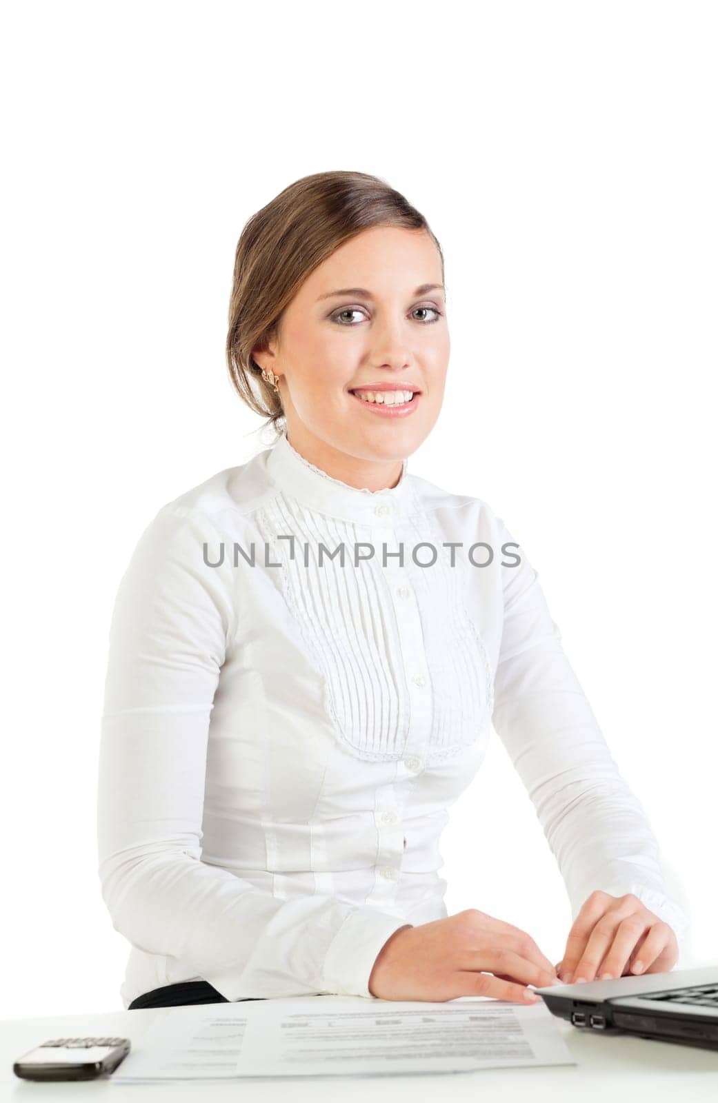 Smiling young businesswoman sitting at her workplace