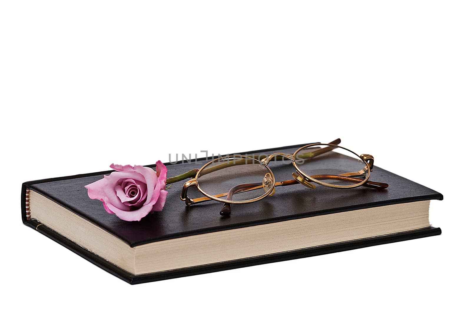 Old books and a pair of glasses isolated over a white background.
