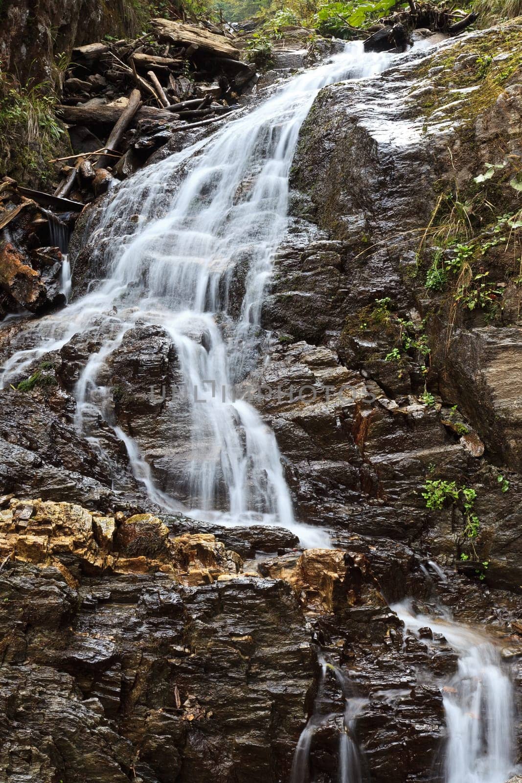 a beautiful waterfall on a mountain slope