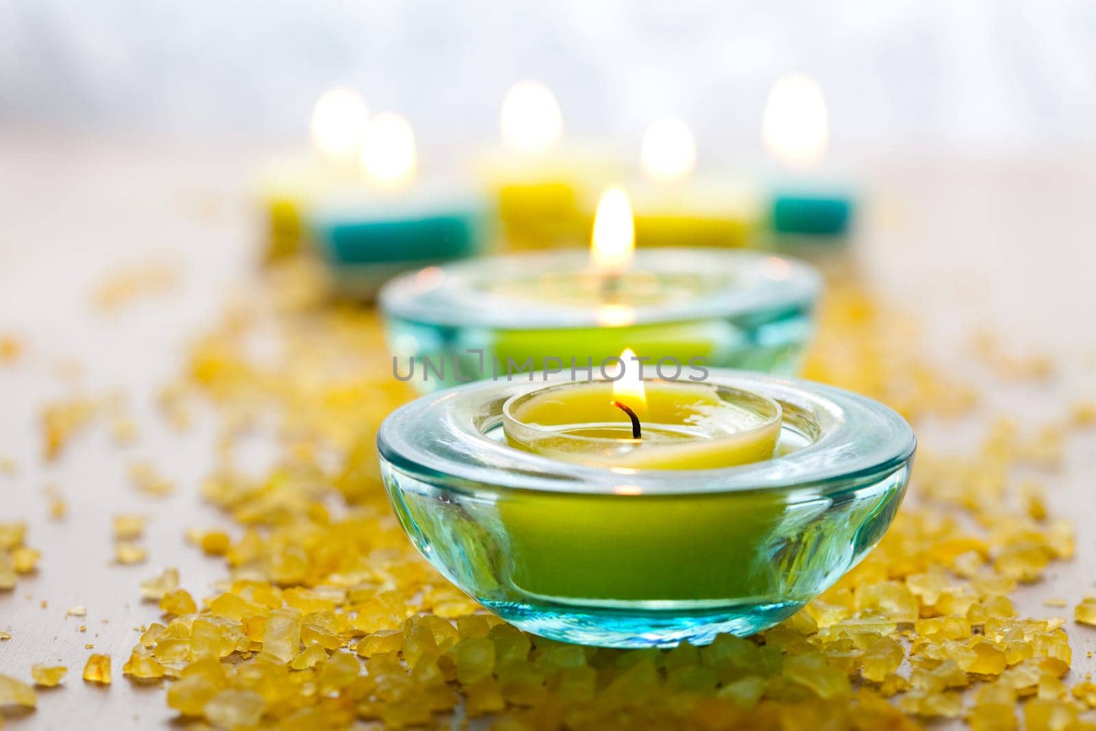 Close-up of blue and yellow candles with yellow bath salt