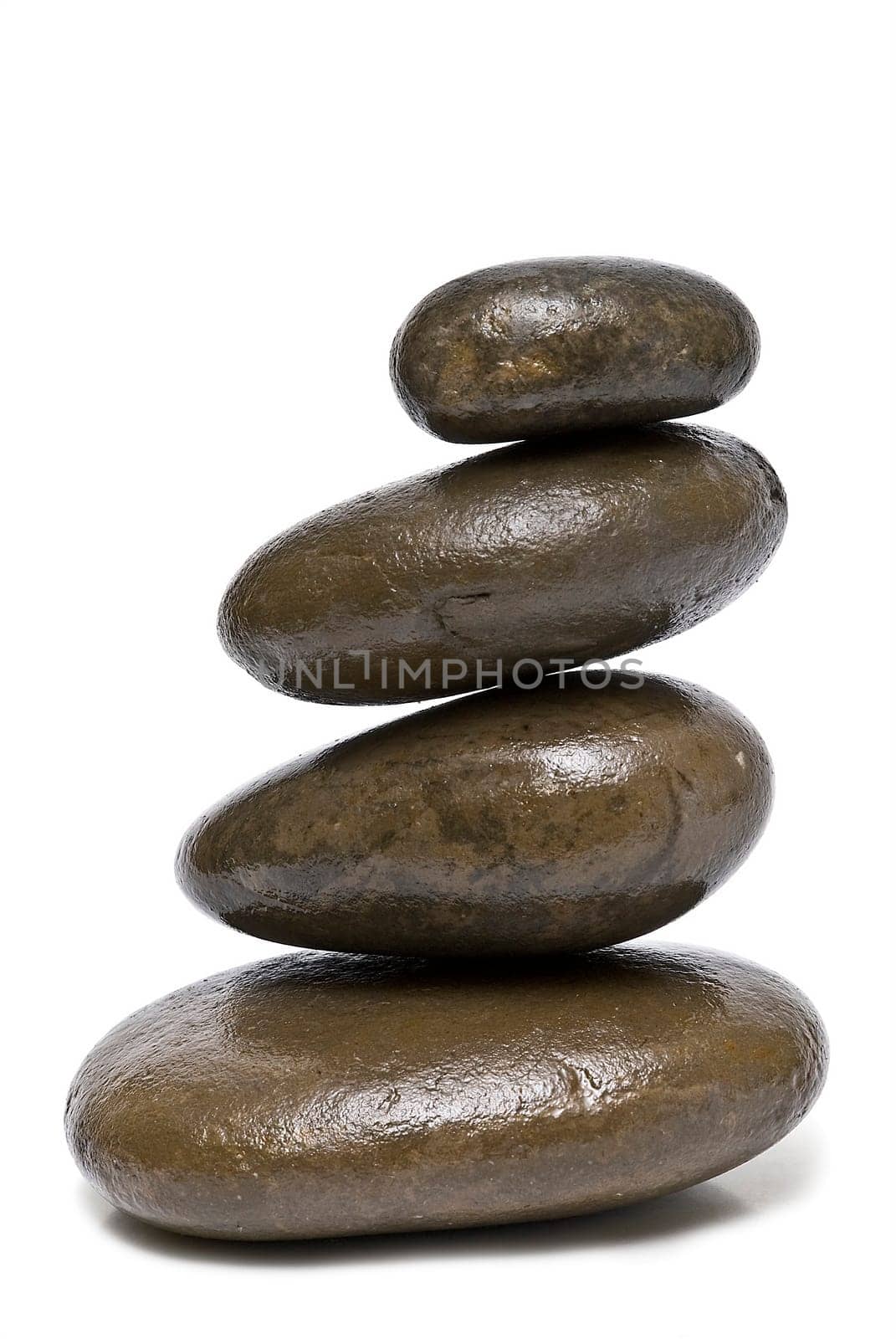 Boulders in zen balance over a white background.