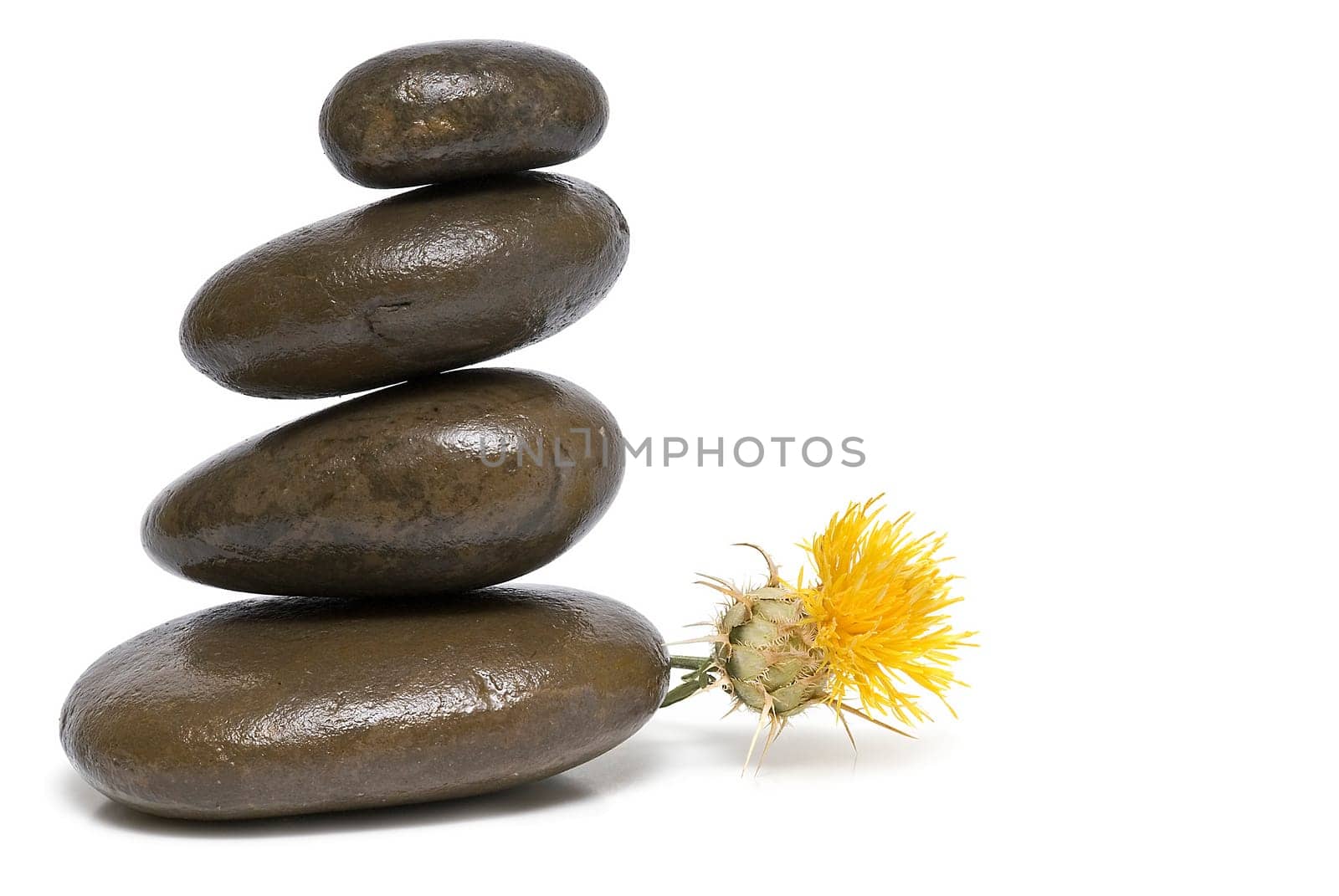 Boulders in zen balance over a white background.