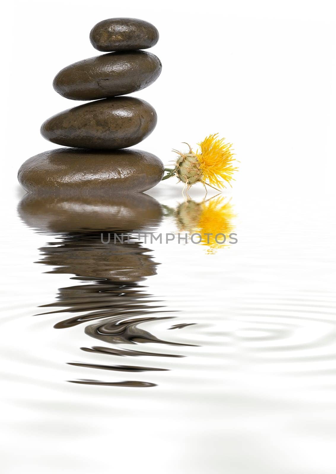 Boulders in zen balance over a white background.