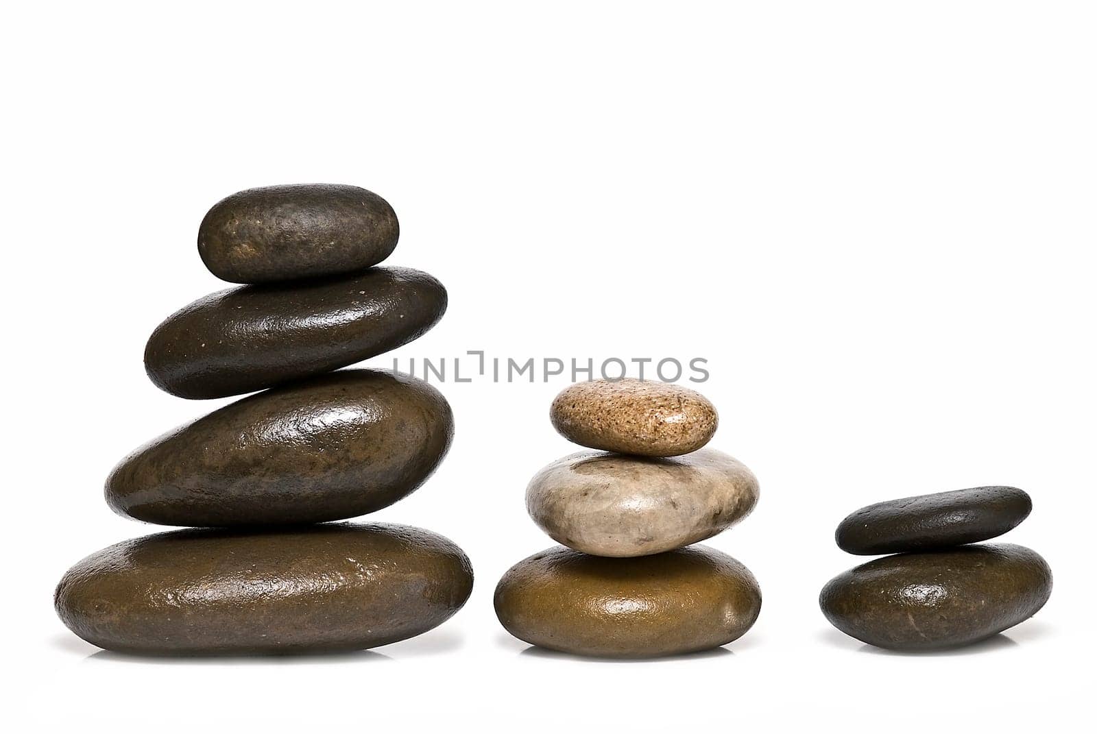Boulders in zen balance over a white background.