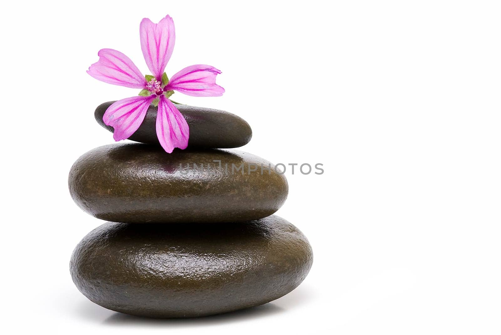 Boulders in zen balance over a white background.
