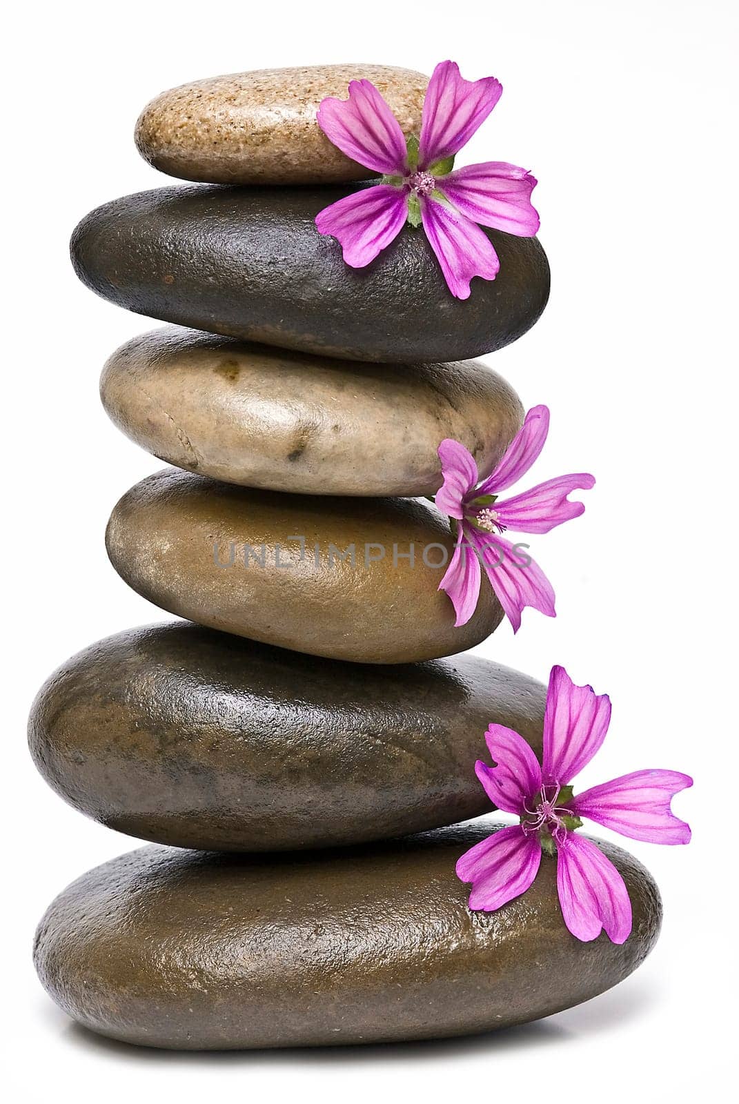 Boulders in zen balance over a white background.