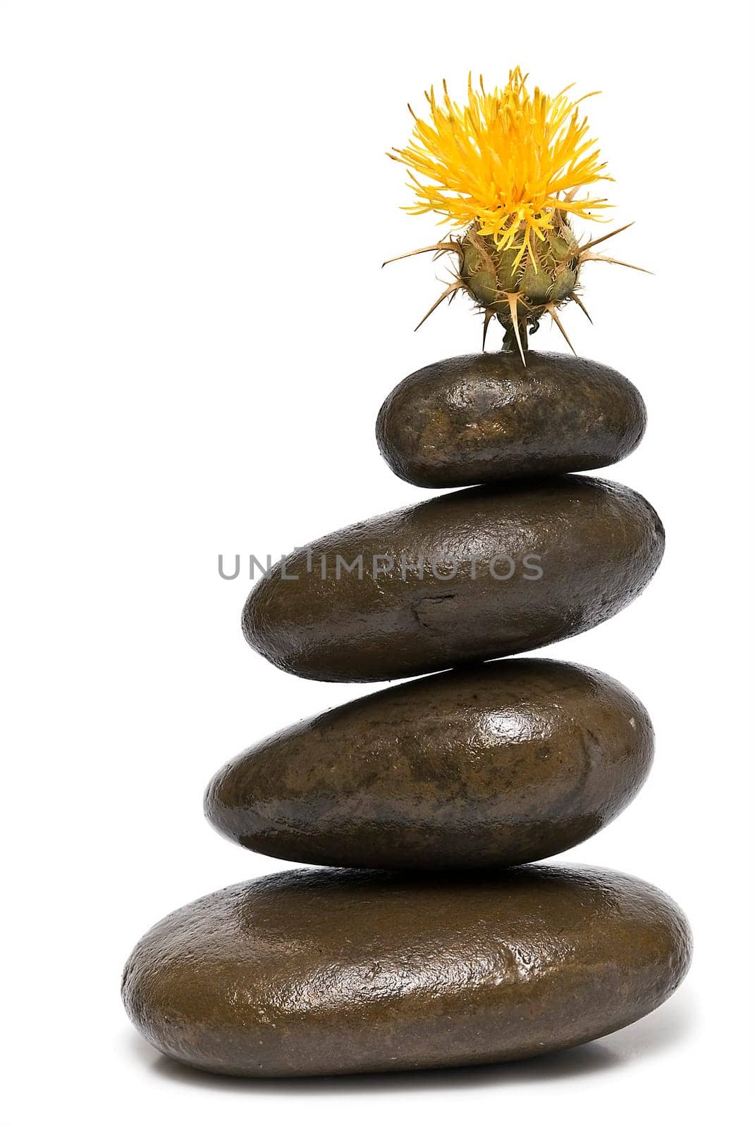 Boulders in zen balance over a white background.
