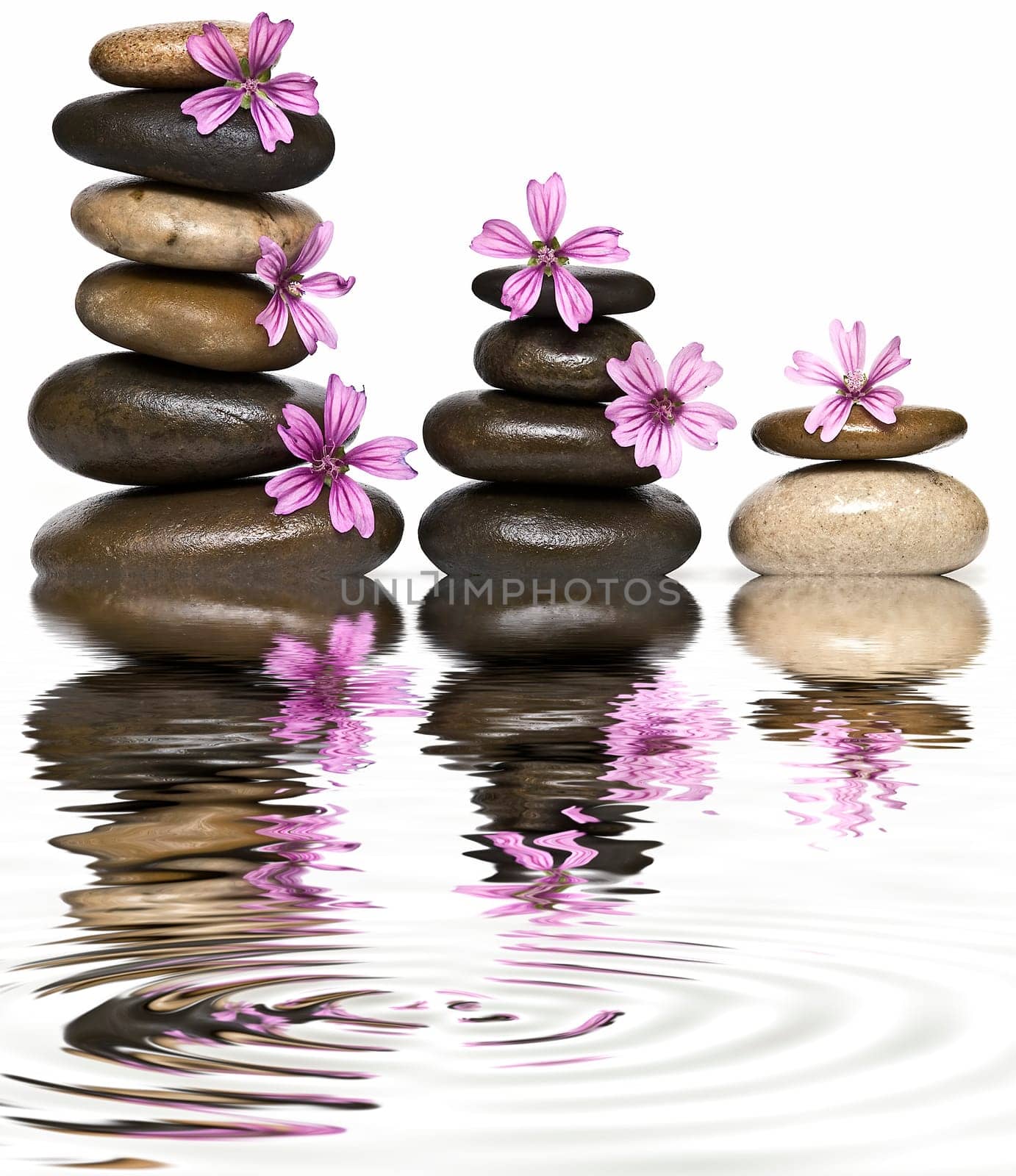 Boulders in zen balance over a white background.