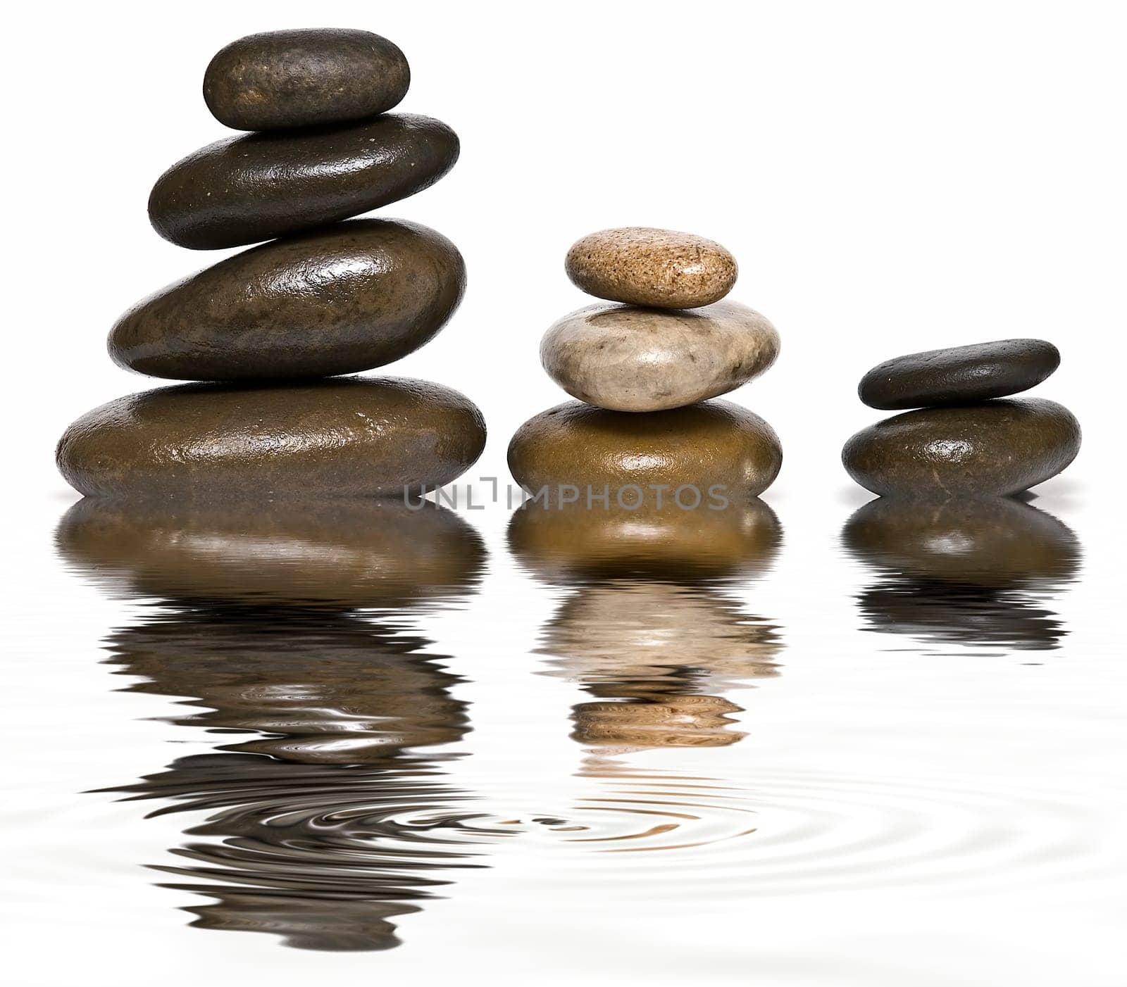 Boulders in zen balance over a white background.