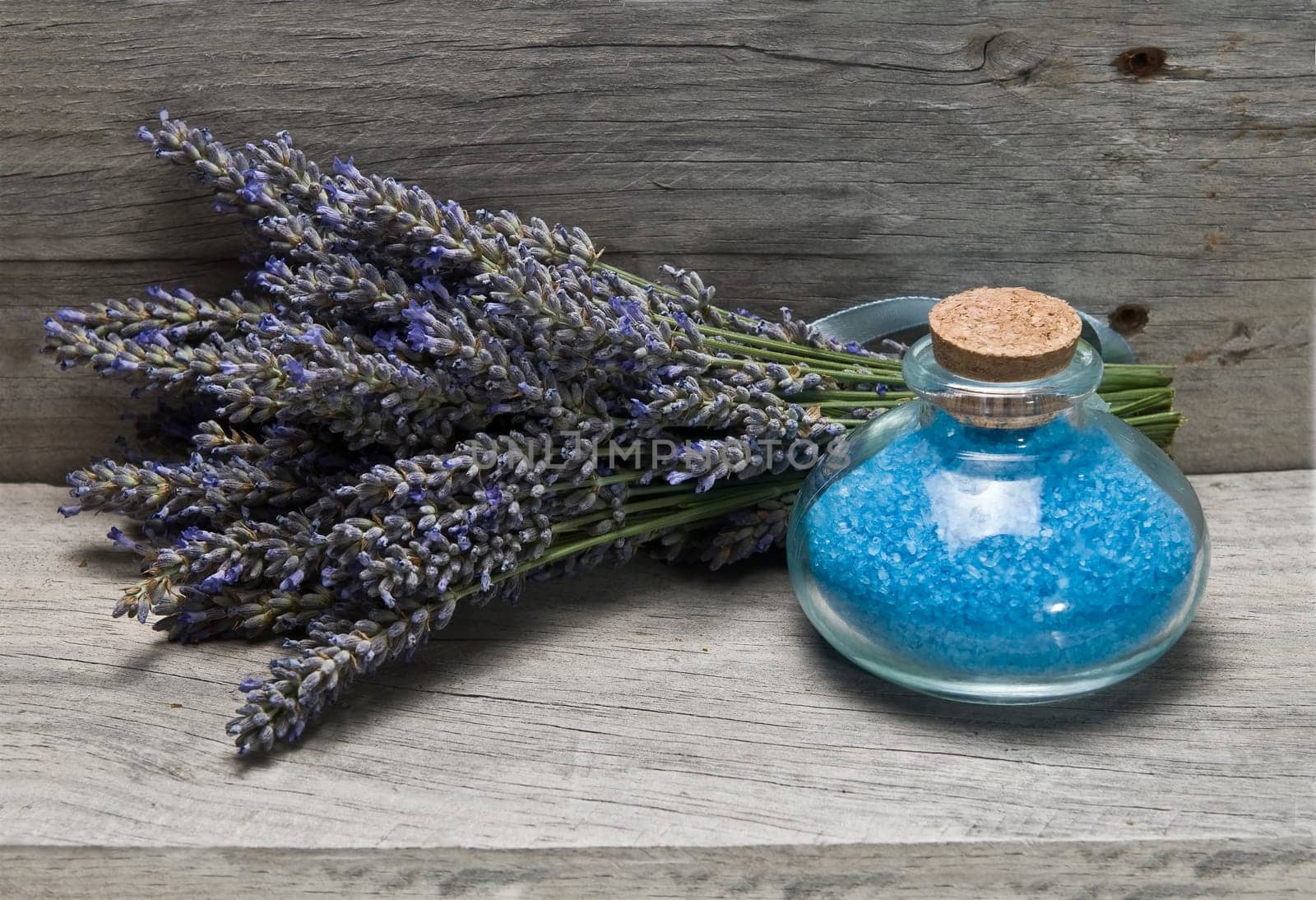Lavender and some hygiene items made of lavender on an old wooden shelf.