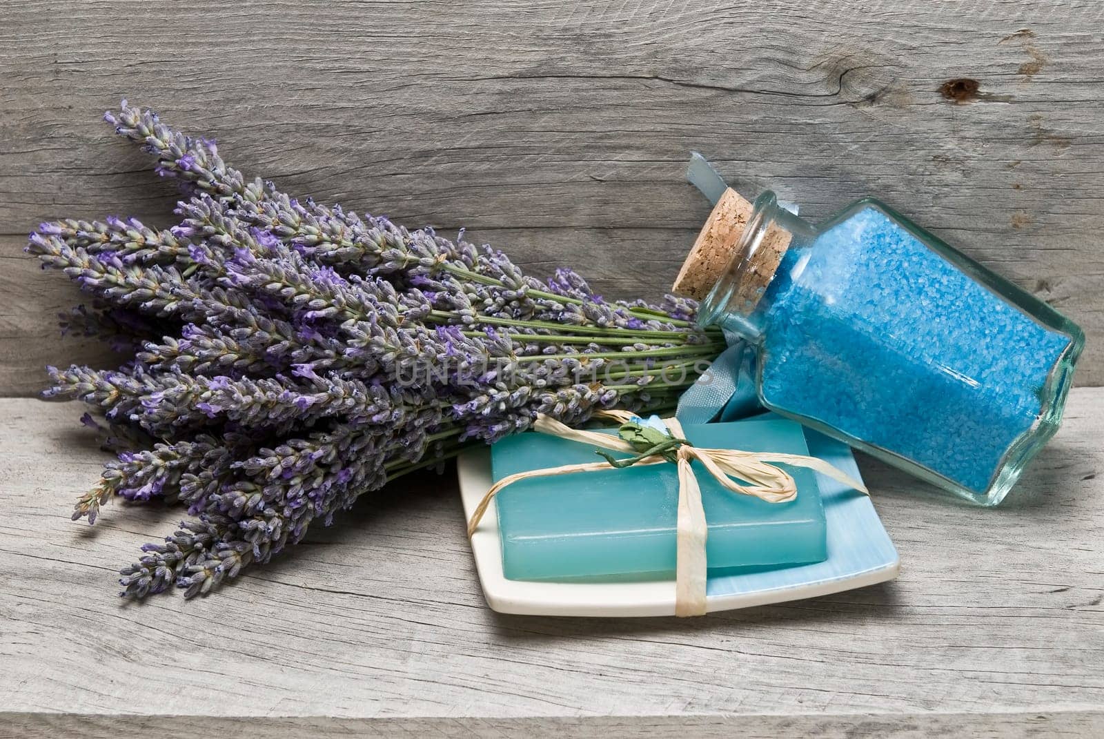 Lavender and some hygiene items made of lavender on an old wooden shelf.