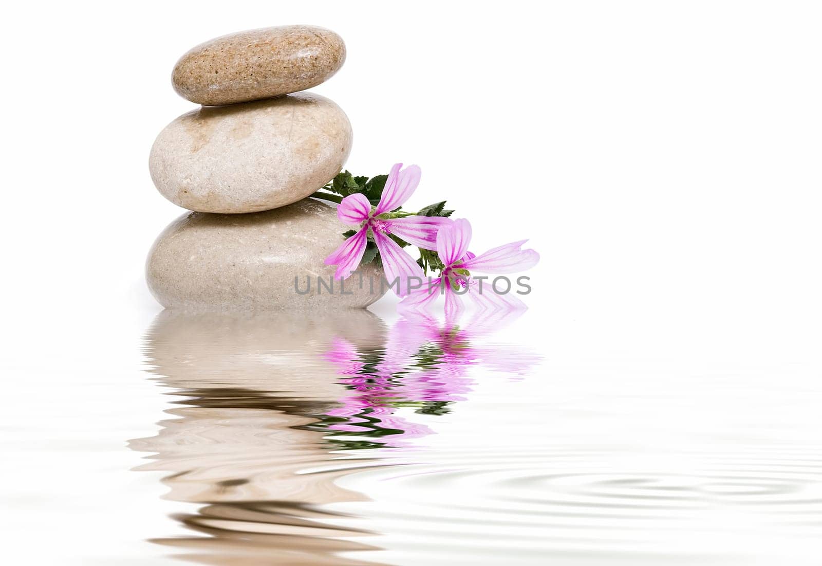 Boulders in zen balance over a white background.