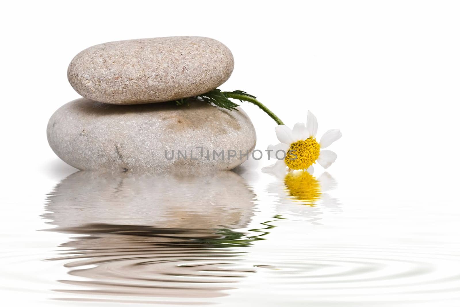Boulders in zen balance over a white background.