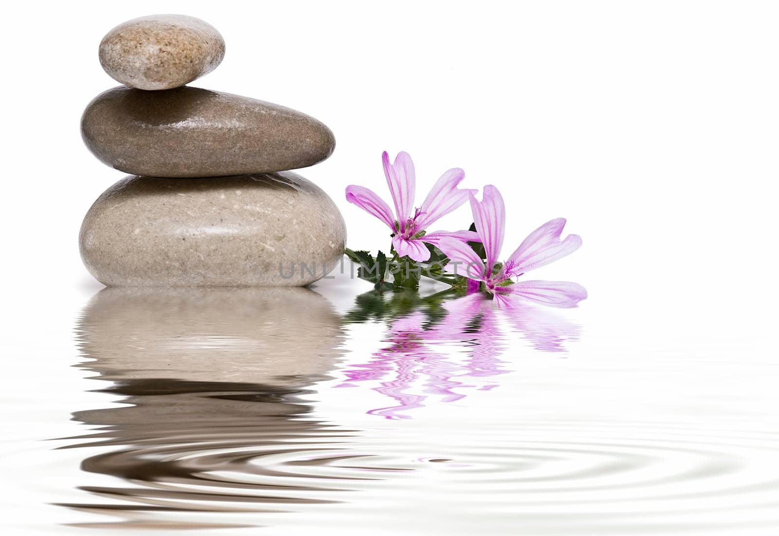 Boulders in zen balance over a white background.