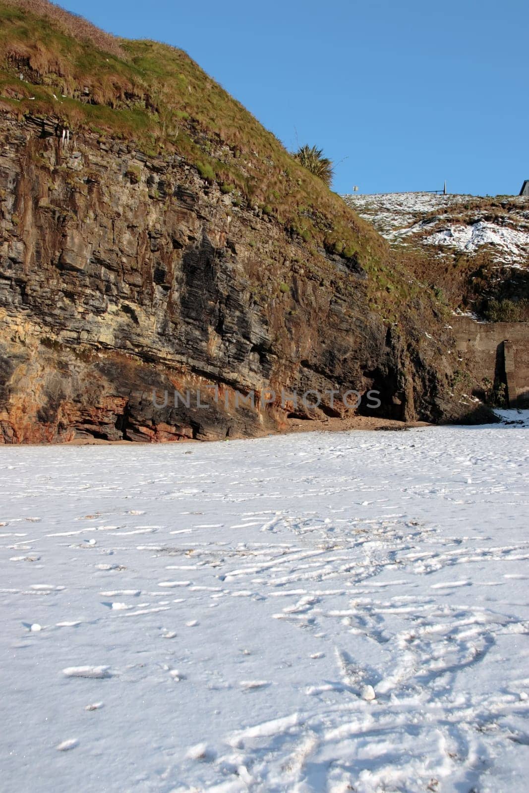 an empty rocky beach and cliffs on a cold winters day