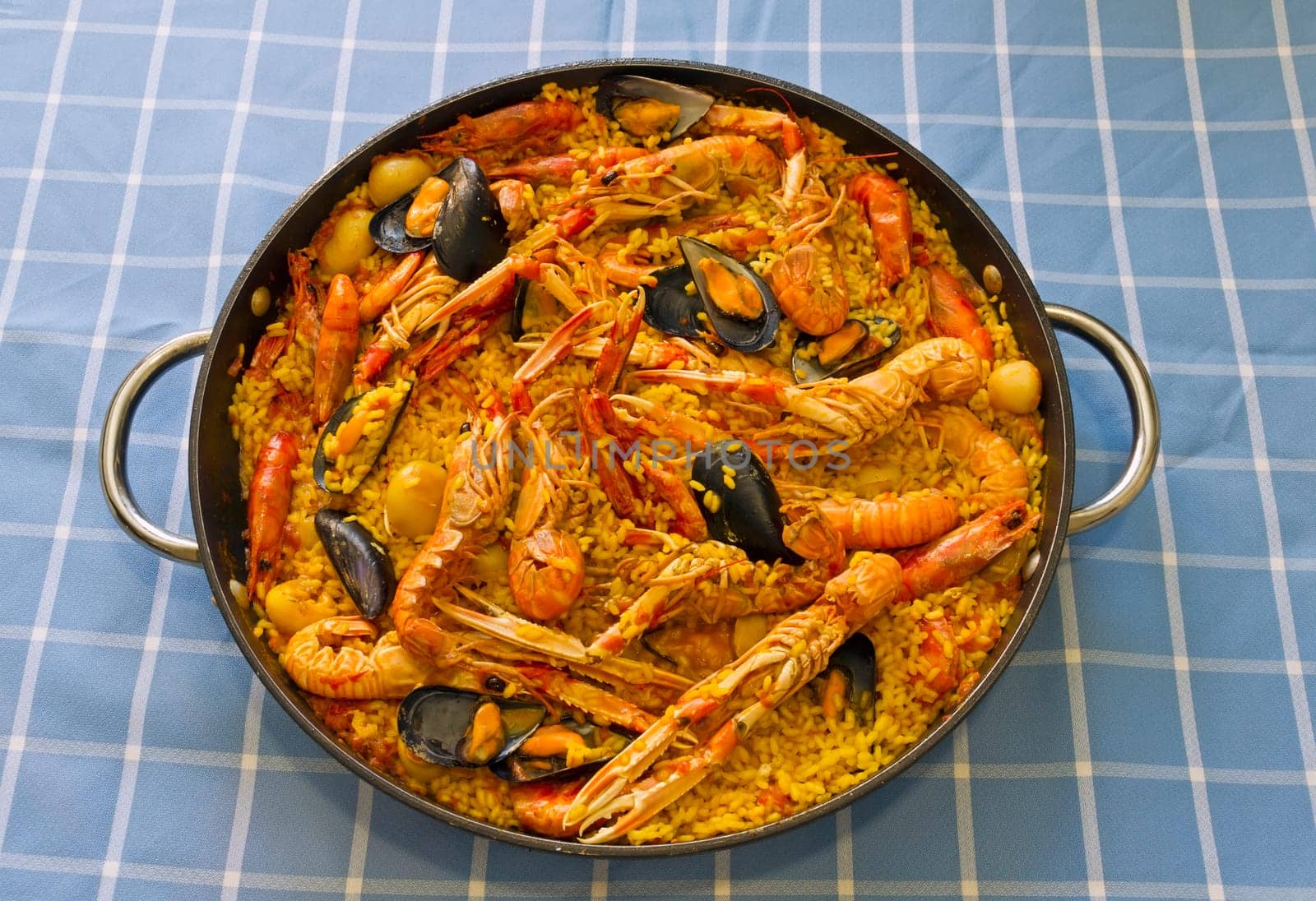 Paella Valenciana, typical food of Spain, based on rice and seafood.