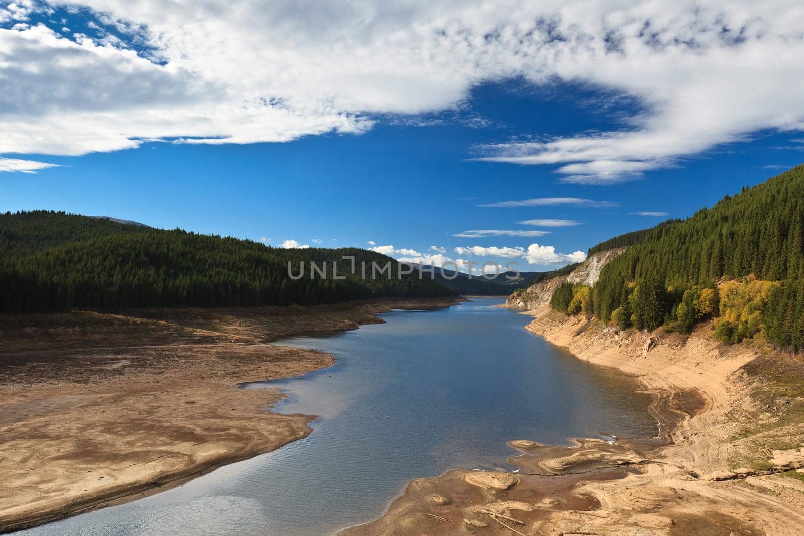 mountain lake and a blue sky with clouds