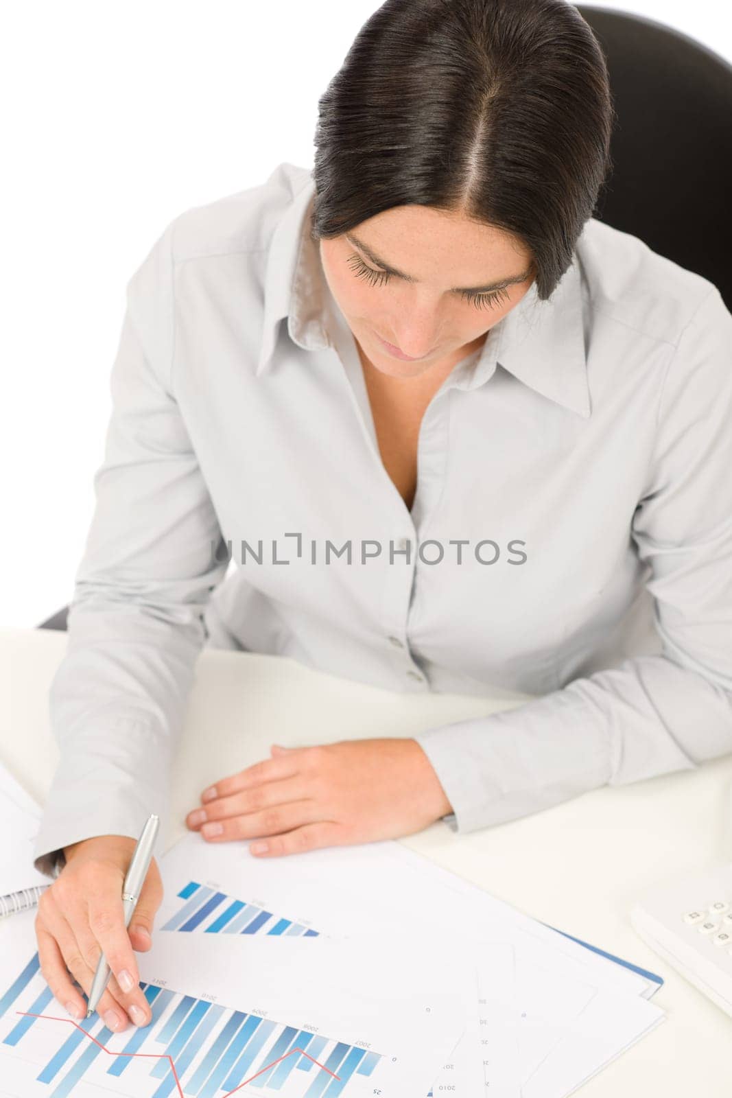 Successful business woman at office thinking working on charts