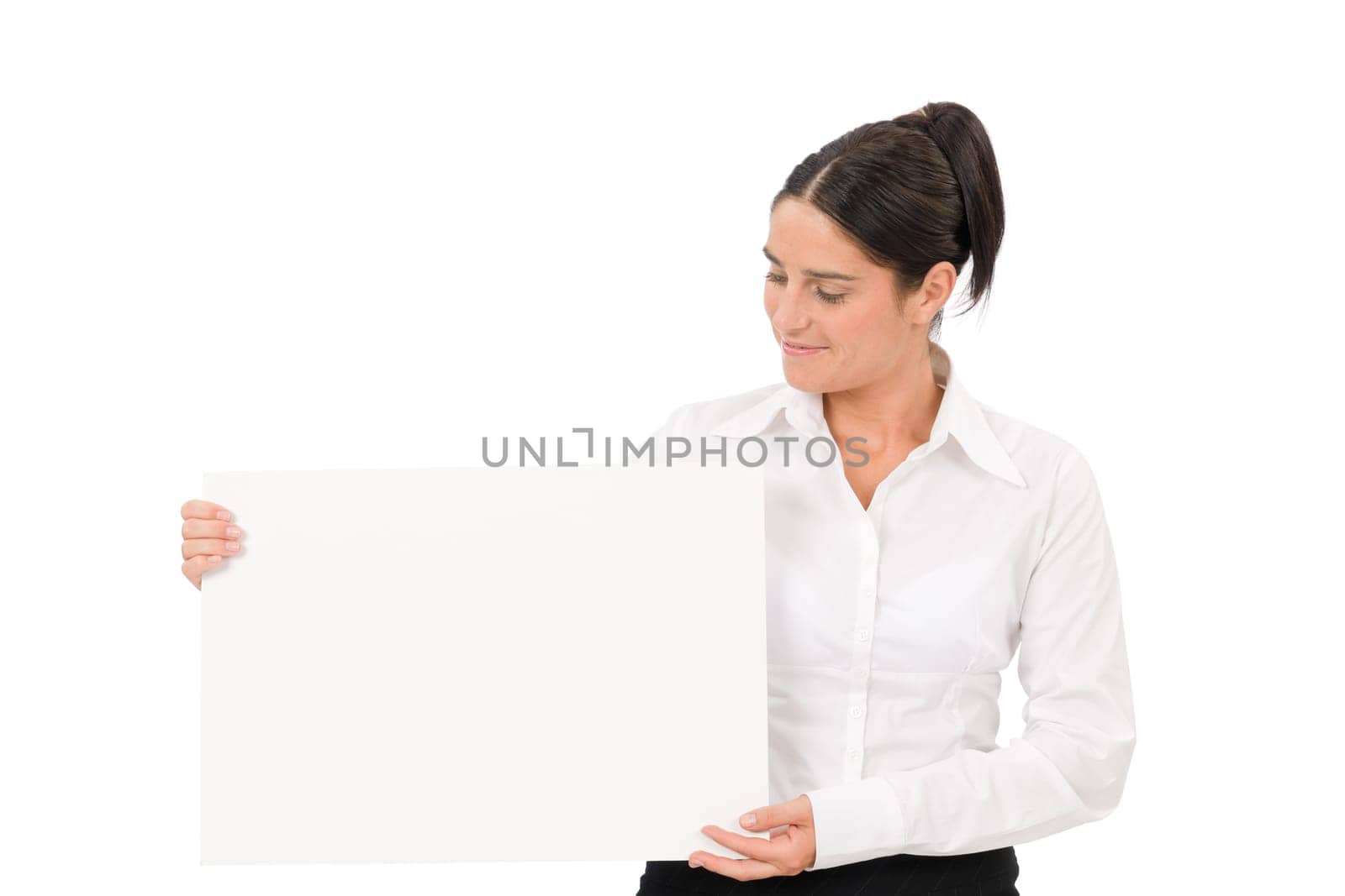 Happy businesswoman looking aside blank advertising banner on white