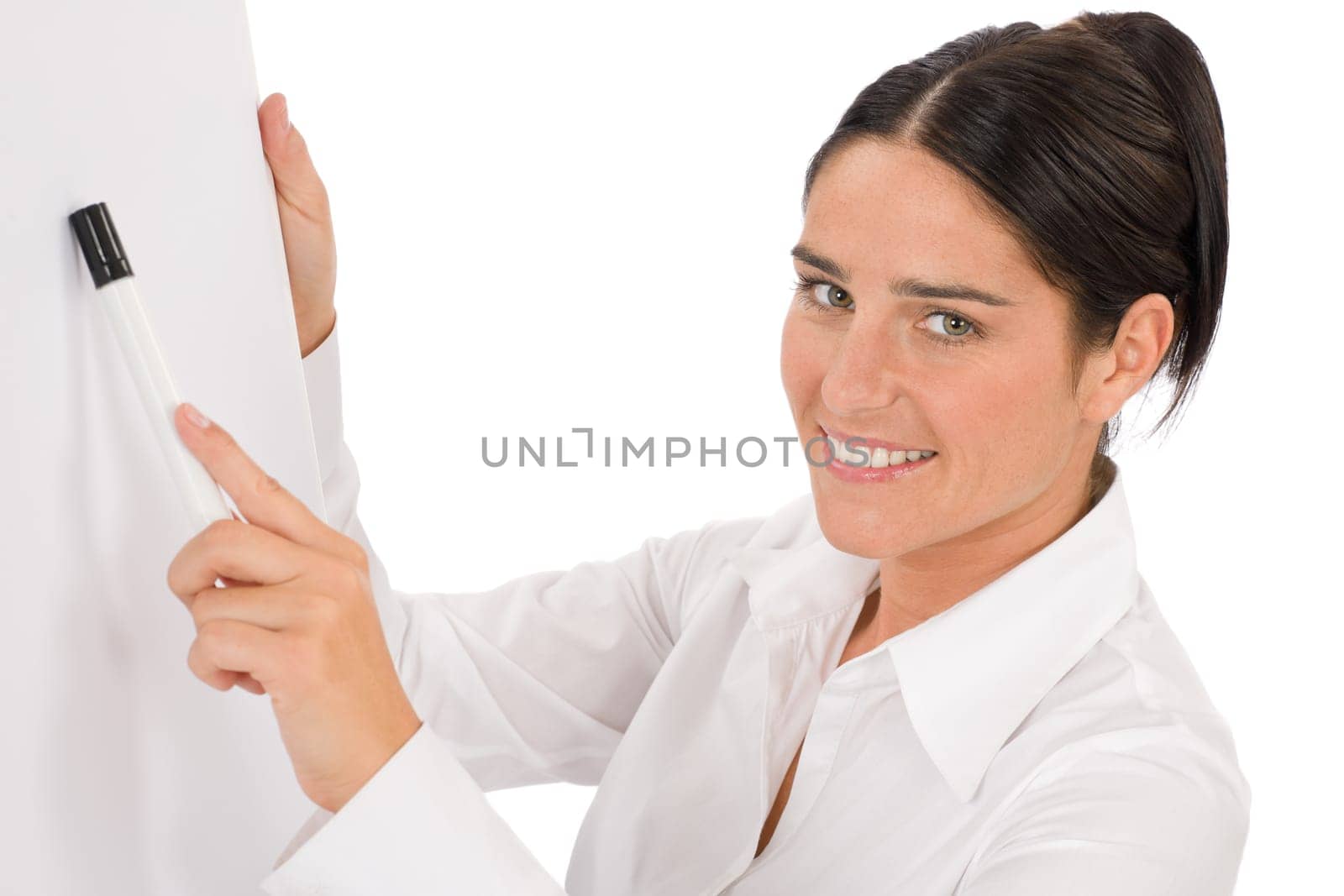 Happy businesswoman pointing at empty flip chart on white