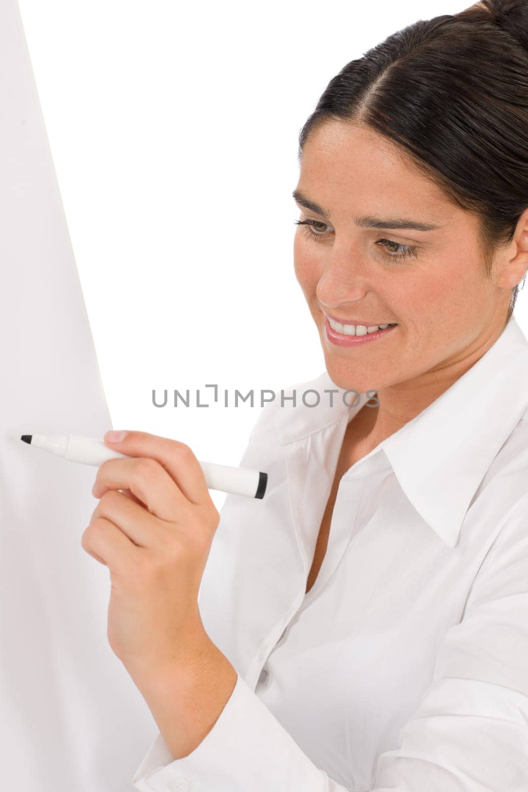 Happy businesswoman writing at empty flip chart on white
