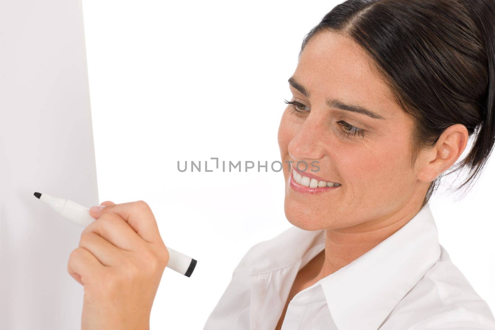 Happy businesswoman writing at empty flip chart on white