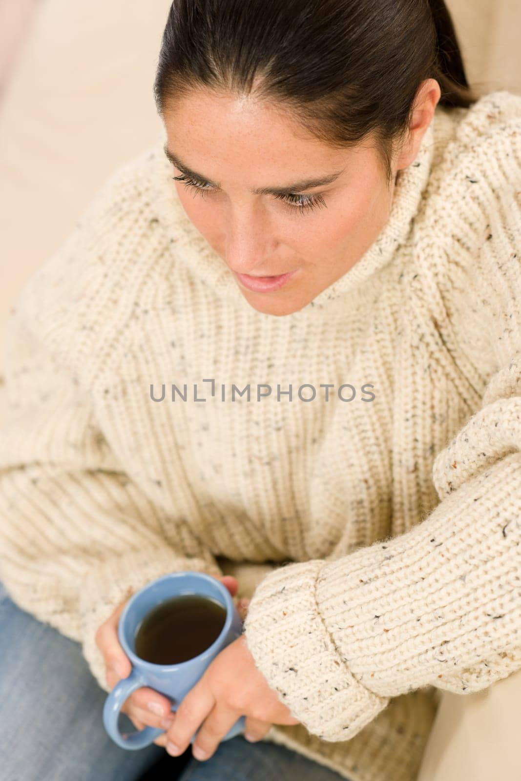 Happy woman with coffee cup wear pullover on white background