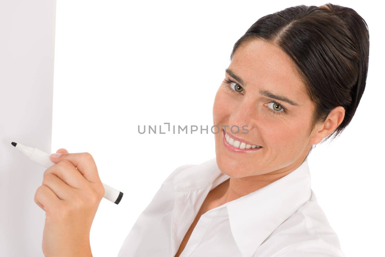 Happy businesswoman writing at empty flip chart on white