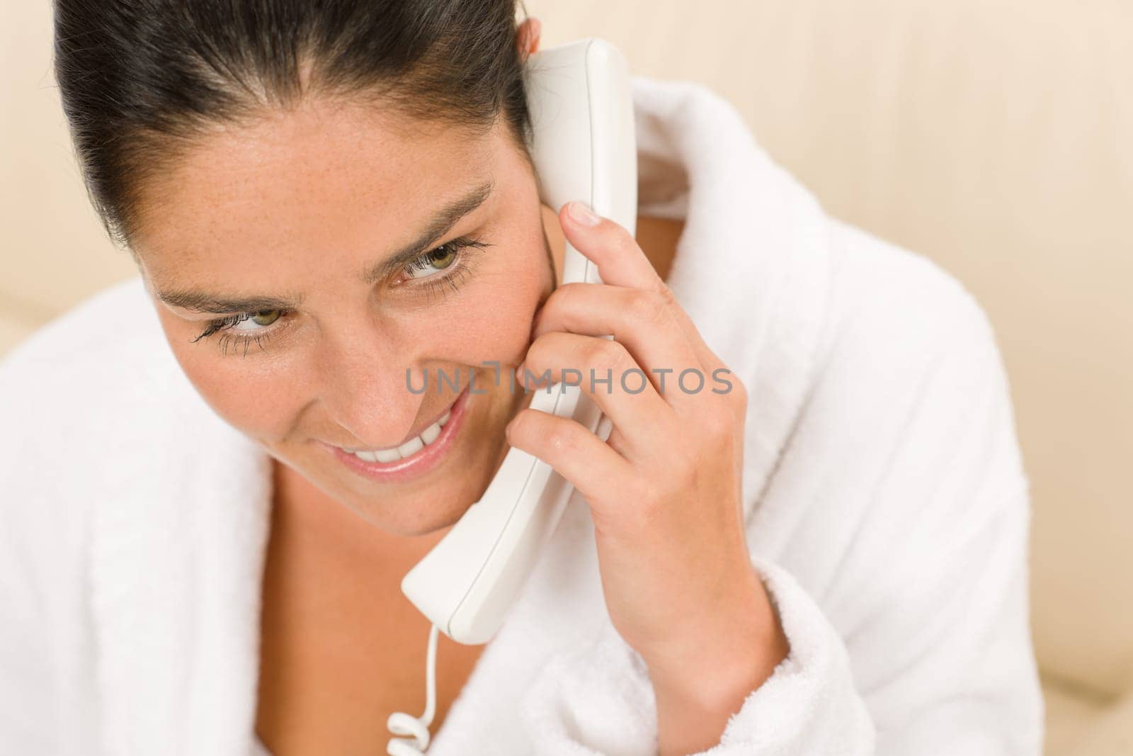 Portrait of attractive mid-aged woman speaking on phone wear bathrobe