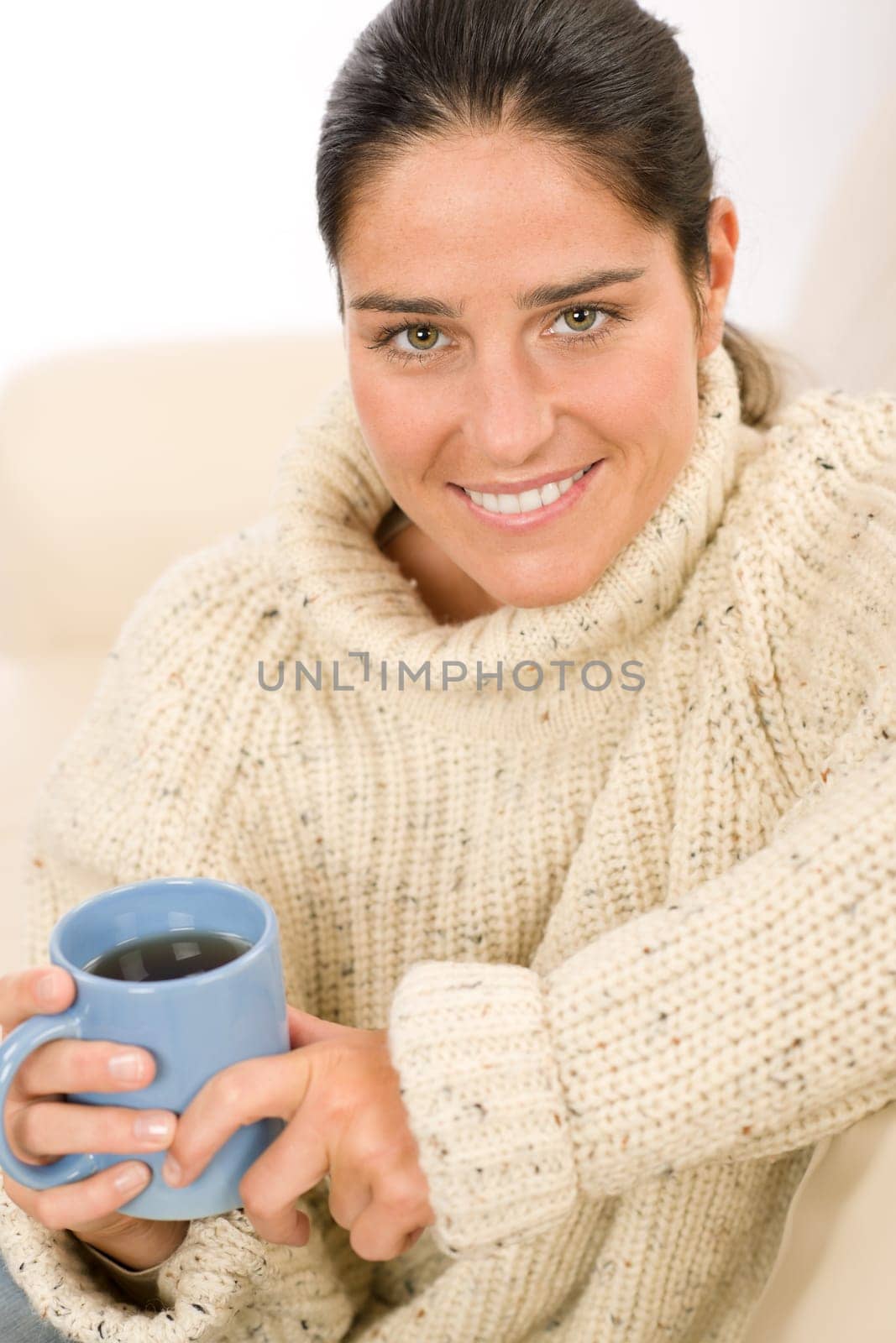 Happy woman with coffee cup wear pullover on white background