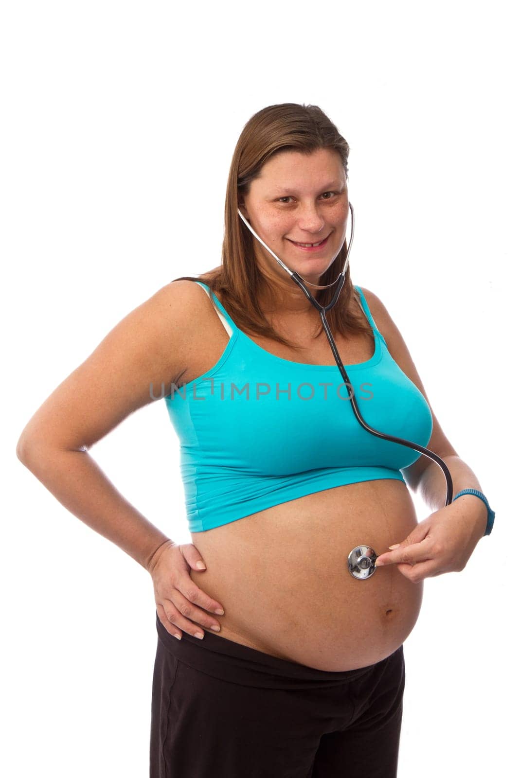 young pregnant woman listening stethoscope of his future child