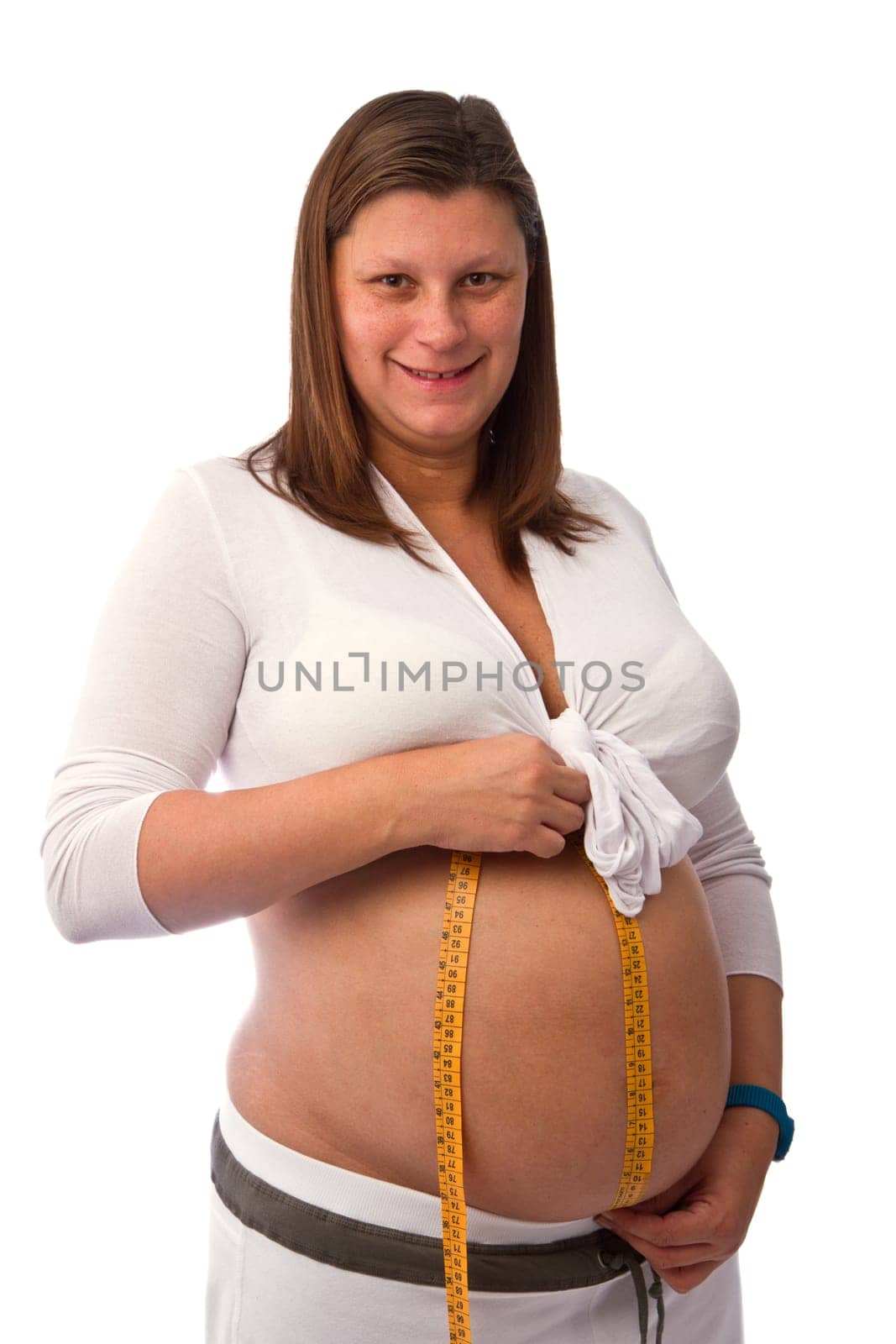 Pregnant woman measuring her baby bump