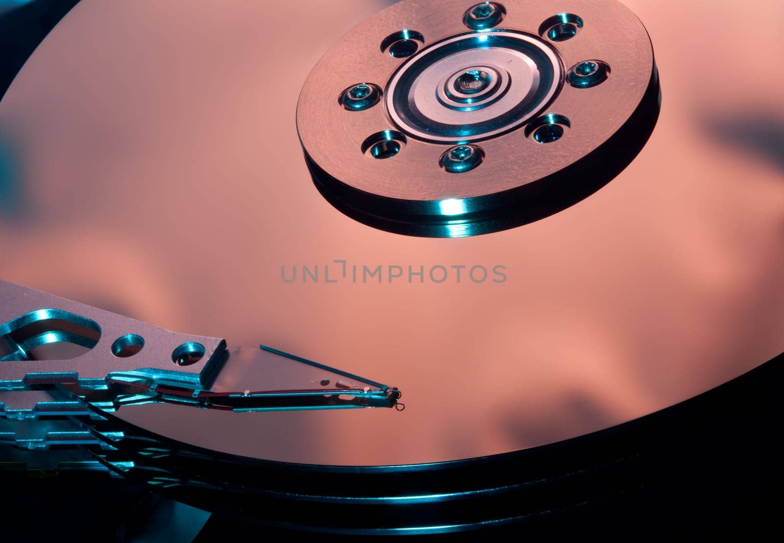 Magnetic disc inside a computer hd unit showing mirror surface of the magnetic discs and read write head