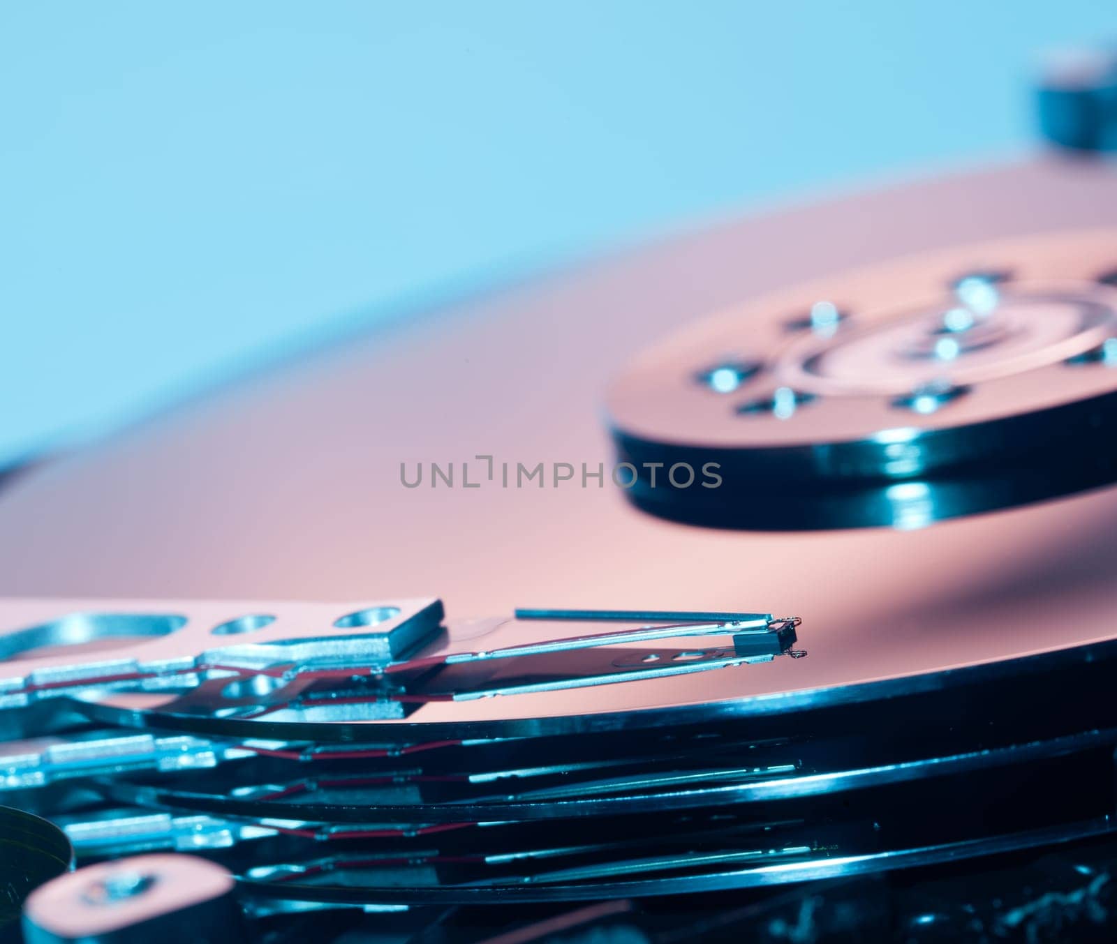 Magnetic disc inside a computer hd unit showing mirror surface of the magnetic discs and read write head