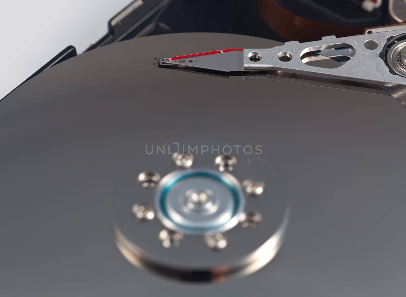 Magnetic disc inside a computer hd unit showing mirror surface of the magnetic discs and read write head