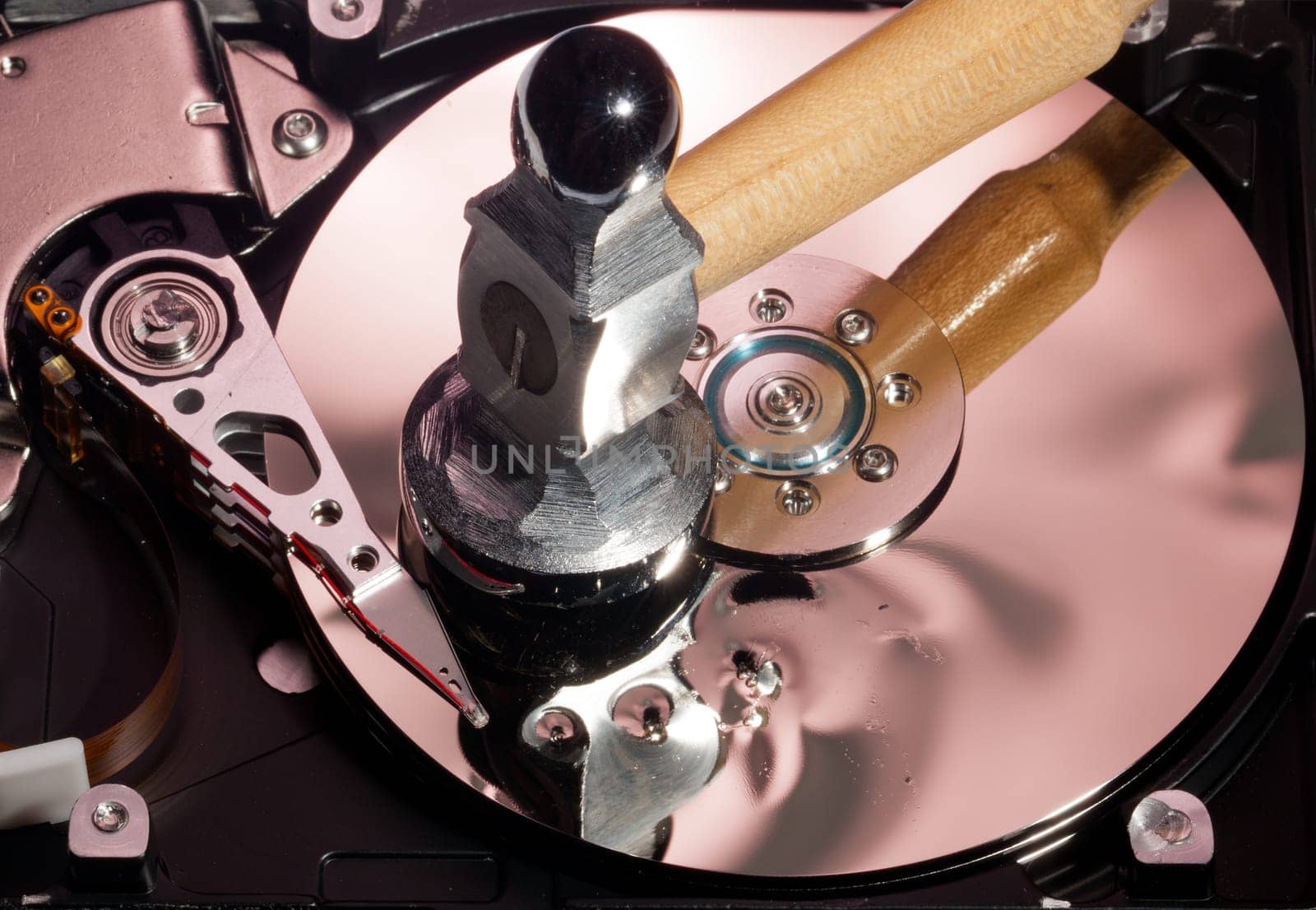 Magnetic disc inside a computer hd unit showing damage to the mirror surface of the magnetic discs and read write head from a hammer