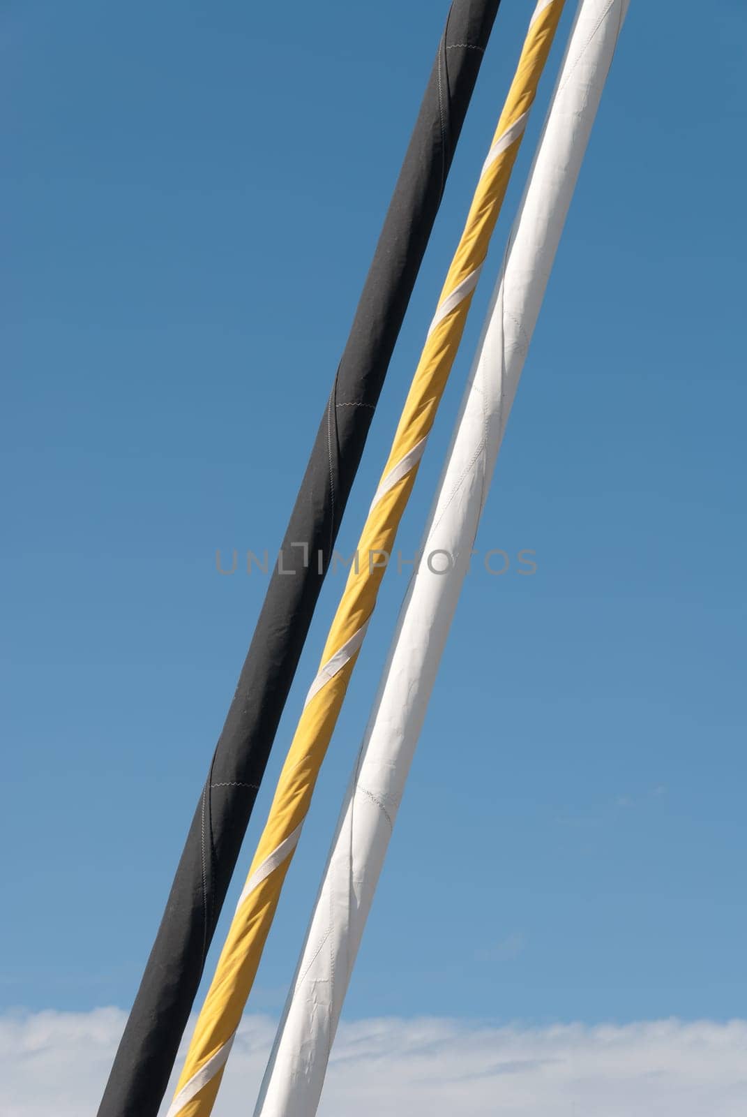 three colored nd rolled sails in Padstow in Cornwall