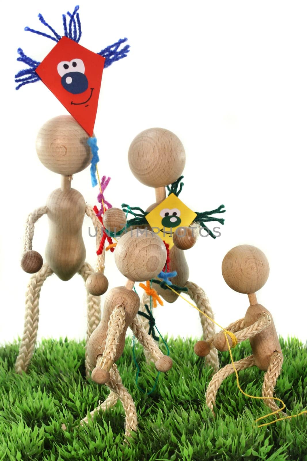 a family of wooden dolls fly kites