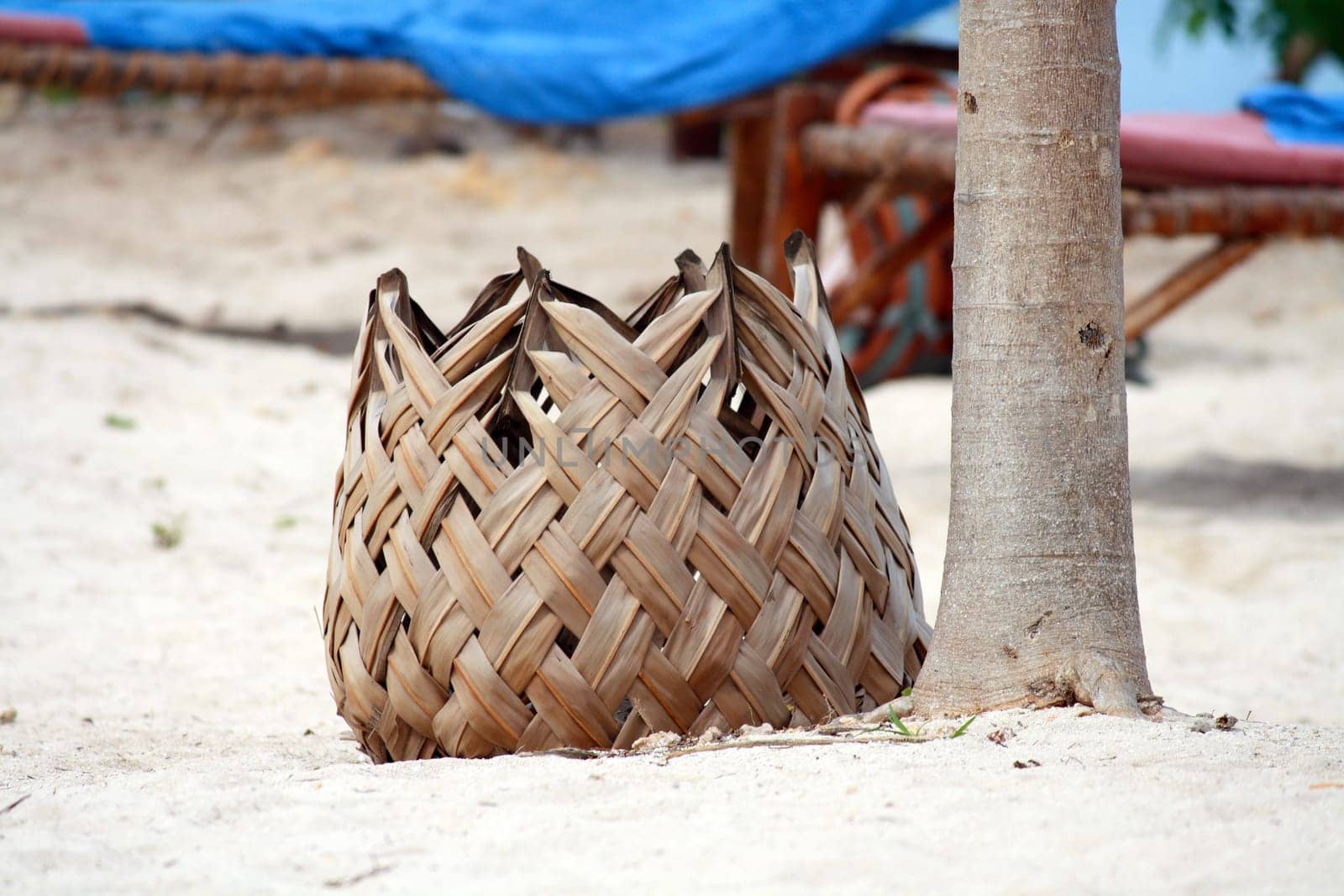 An unusual bin made of palm leaves