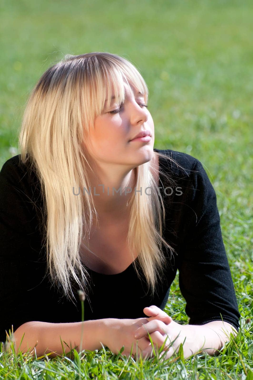 Young woman lying on a meadow